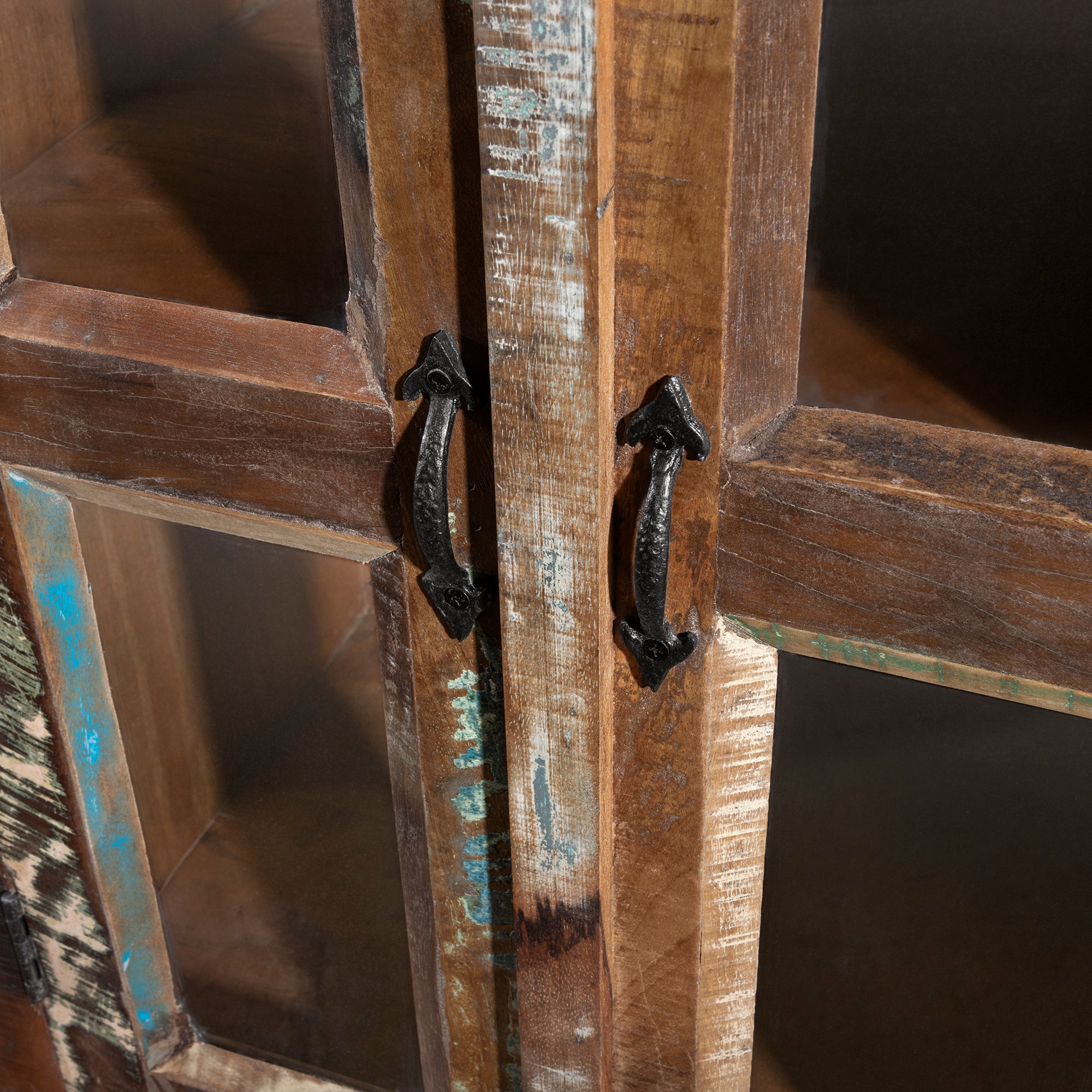 Close-up of hand-forged iron handles on reclaimed wood glass-door buffet, rustic Western hardware detail