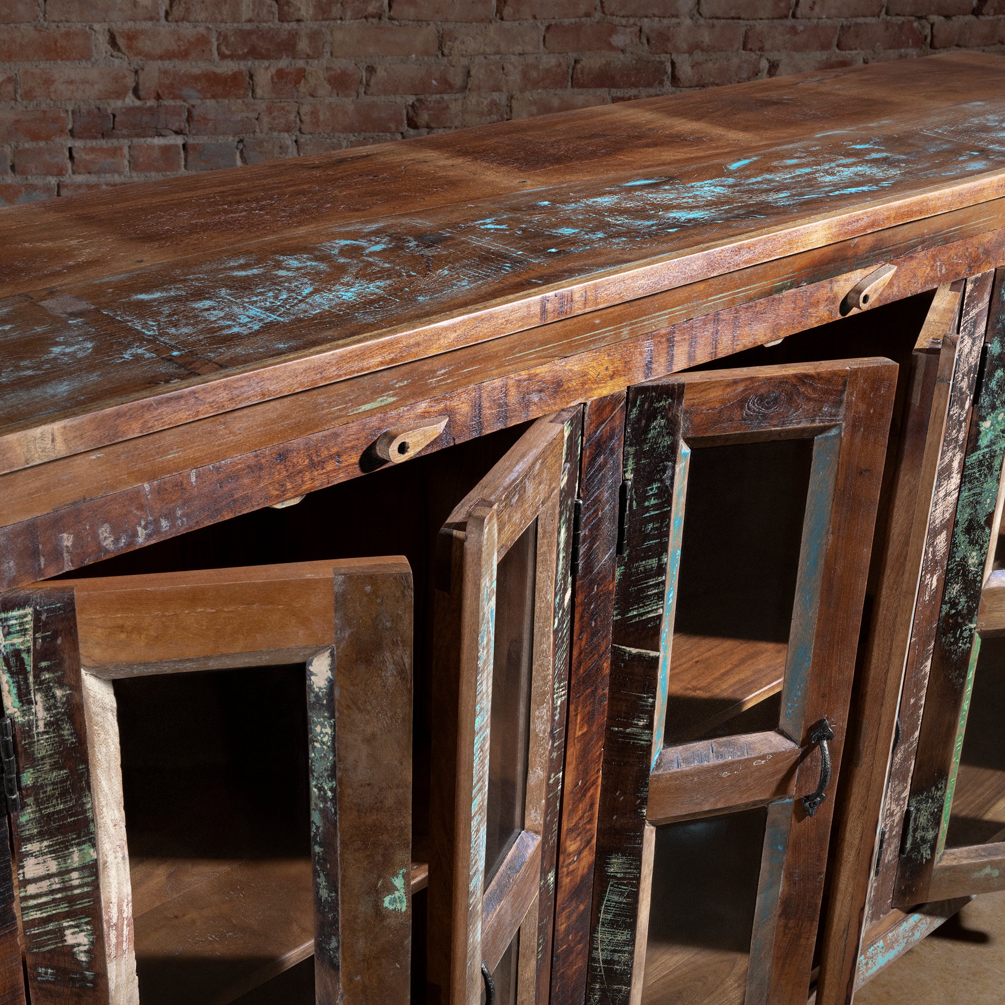 Close-up of reclaimed wood glass-front buffet with doors open and top surface detail, Western sideboard craftsmanship