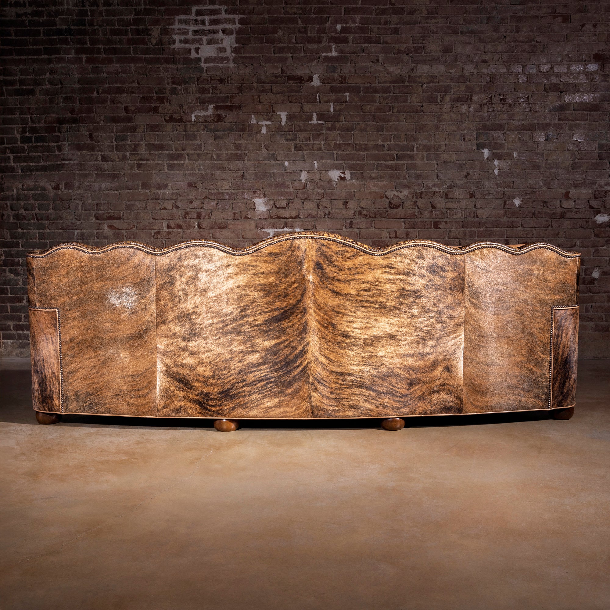 Full back view showing Brazilian brindle cowhide on Western leather statement sofa