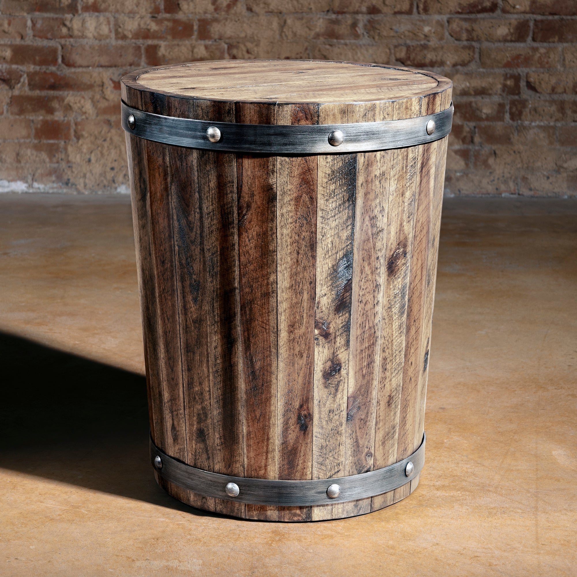 Barrel-shaped reclaimed wood accent table with dark metal bands and rivet details