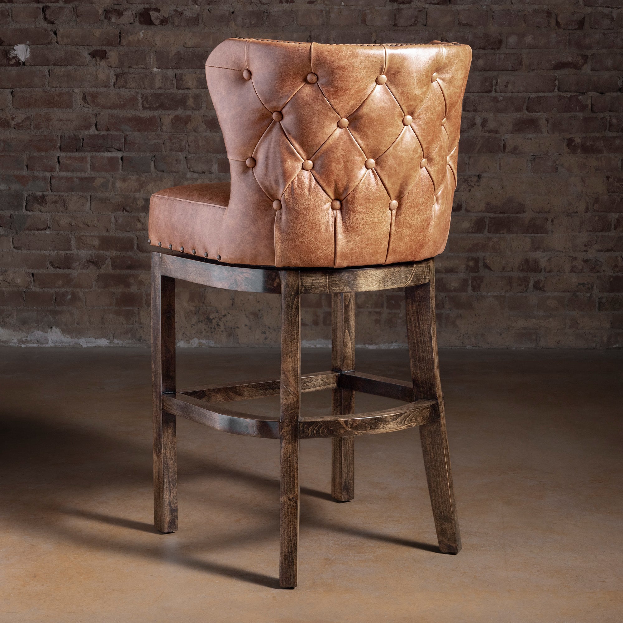 Back view of Catalina curved back leather bar stool showing tailored upholstery and nailhead border