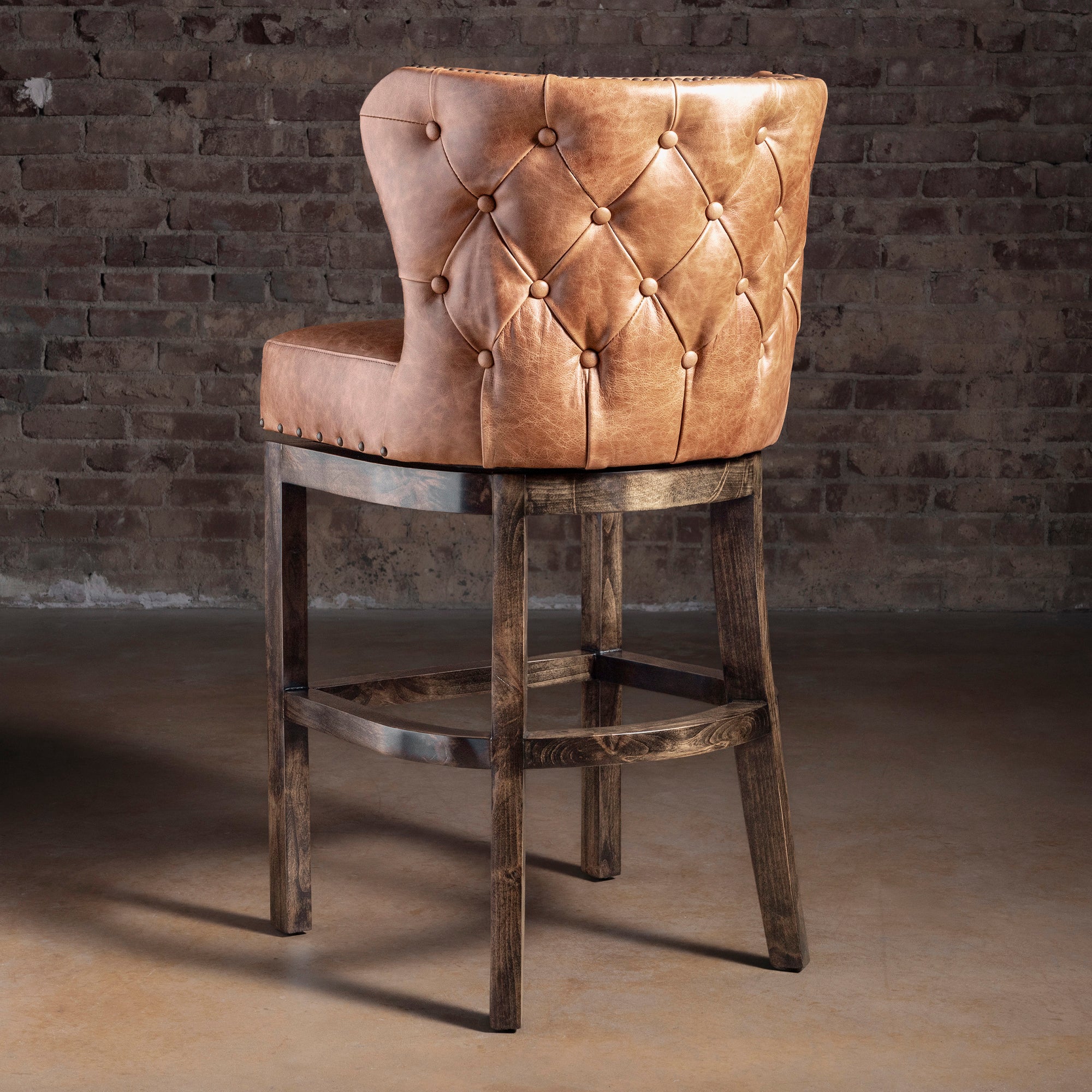 Back view of Catalina curved back leather bar stool showing tailored upholstery and nailhead border