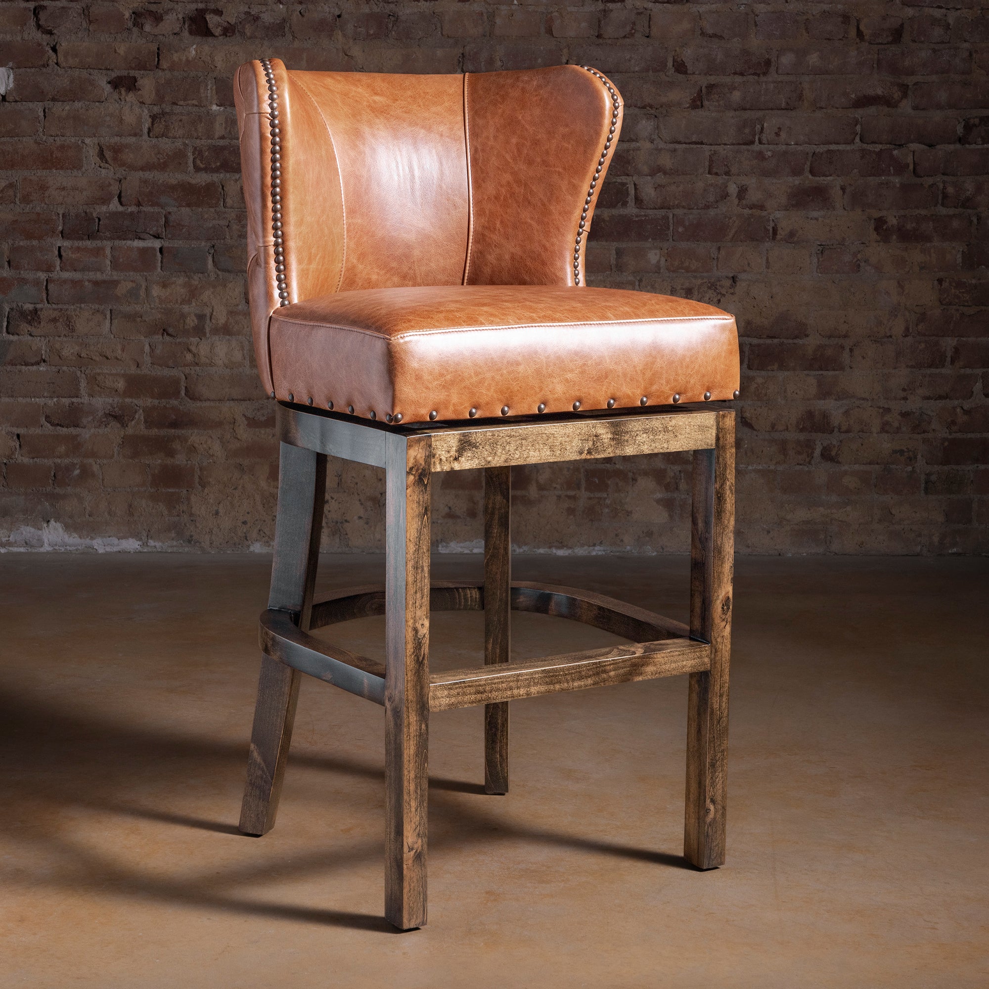 Catalina Curvedback Leather Bar Stool in saddle tan leather with curved back and nailhead trim