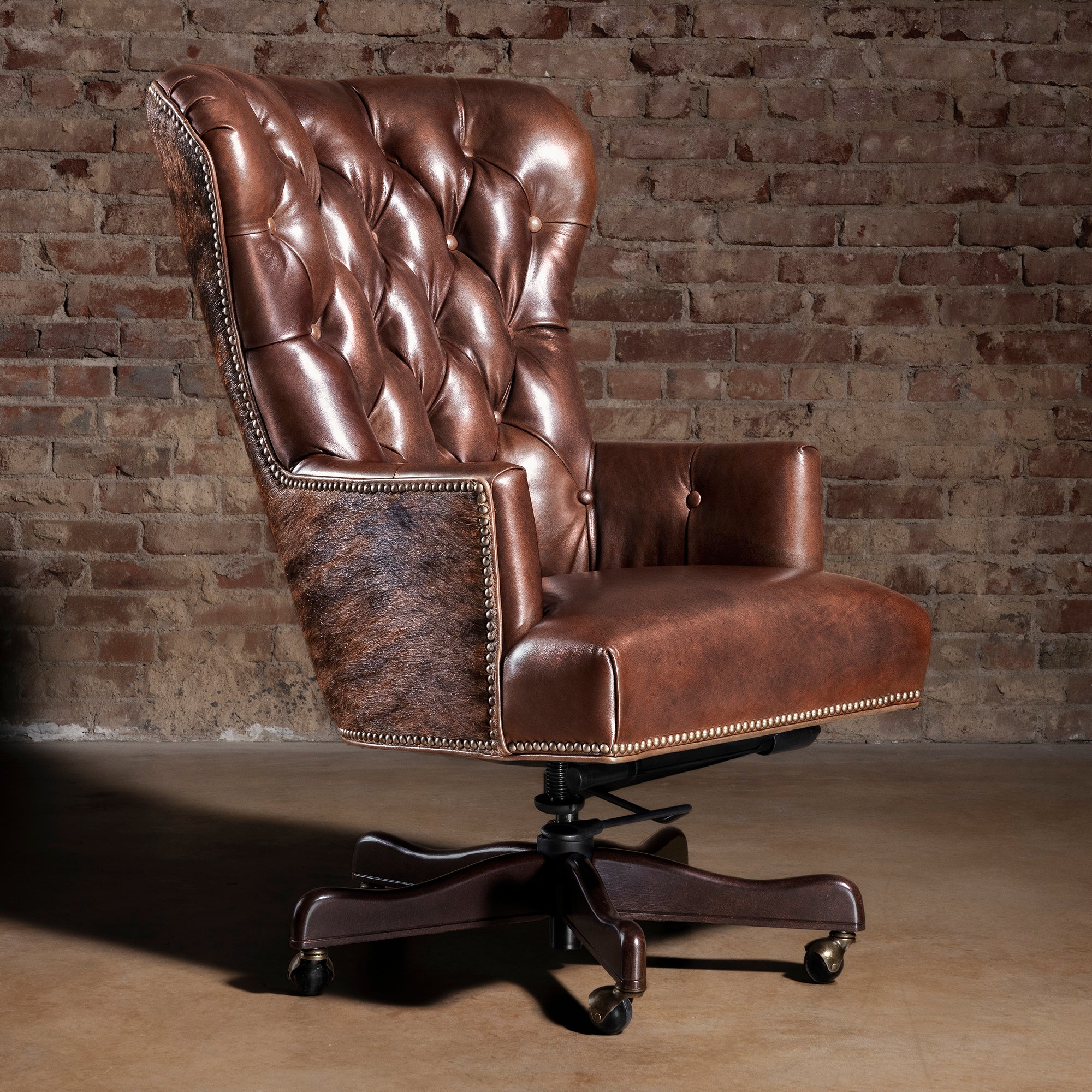 Tufted brown leather executive desk chair with Brazilian brindle cowhide panels and nailhead trim
