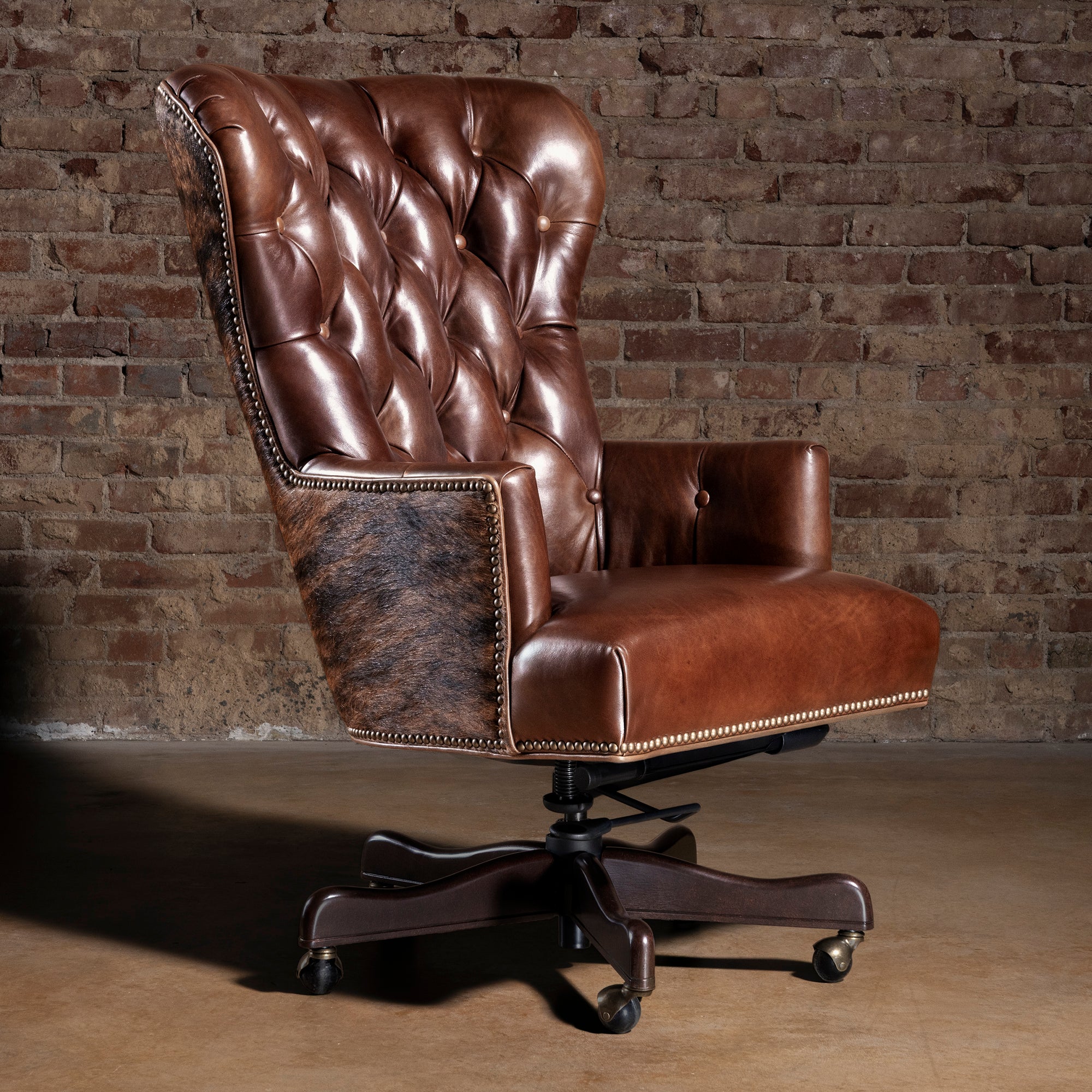 Tufted brown leather executive desk chair with Brazilian brindle cowhide panels and nailhead trim