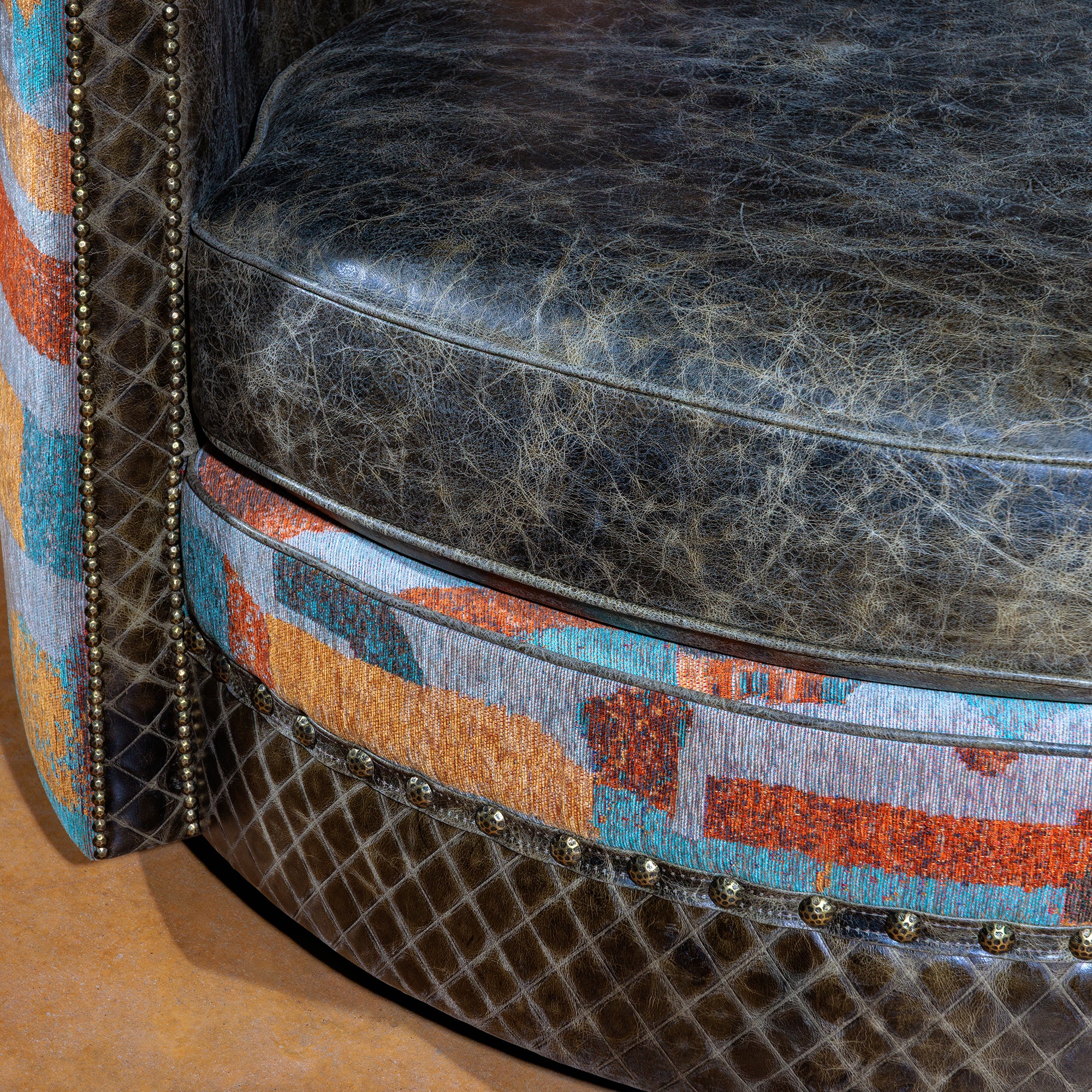 Close-up of quilted leather seat and vibrant fabric trim