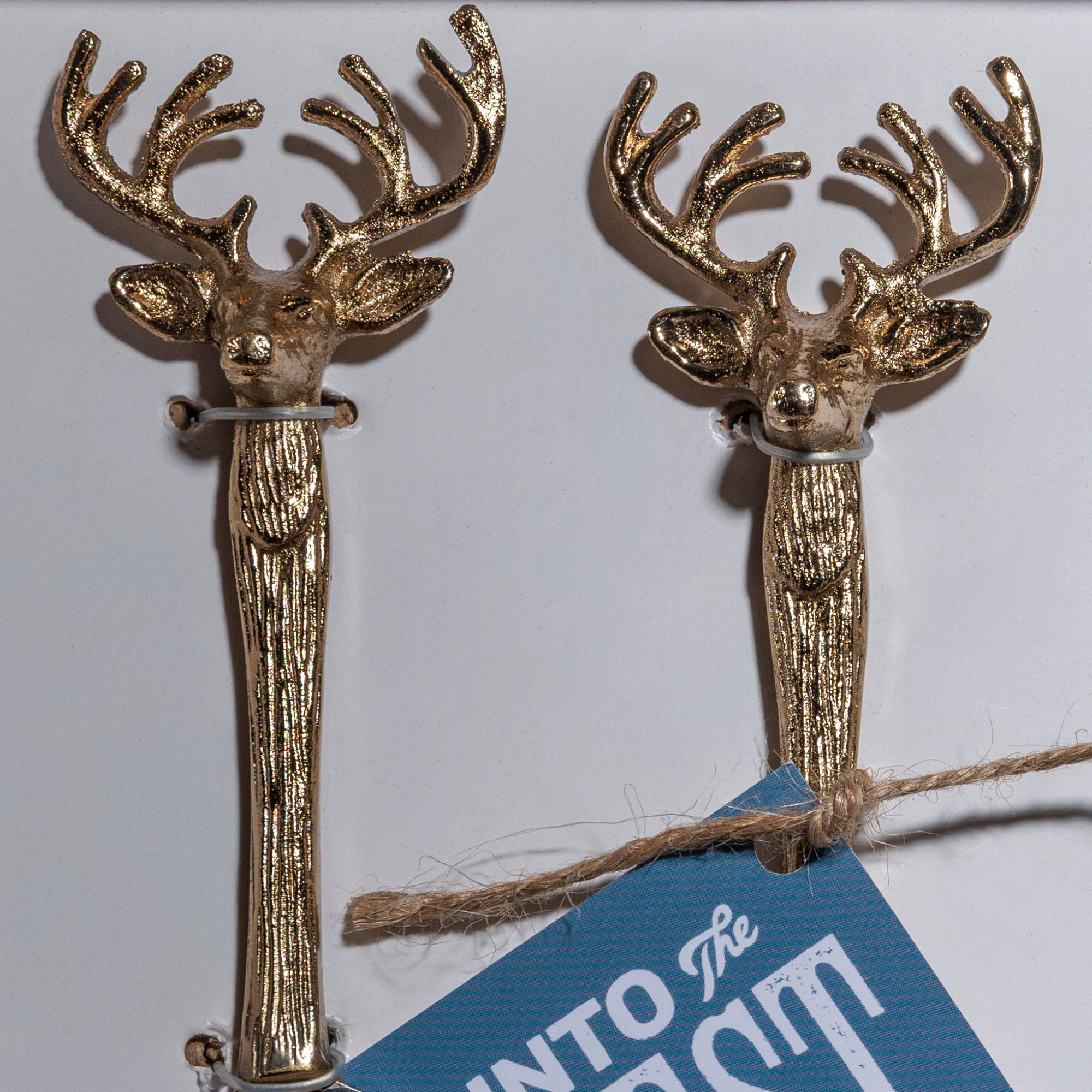 Close-up of antler-shaped golden handles on cheese utensils