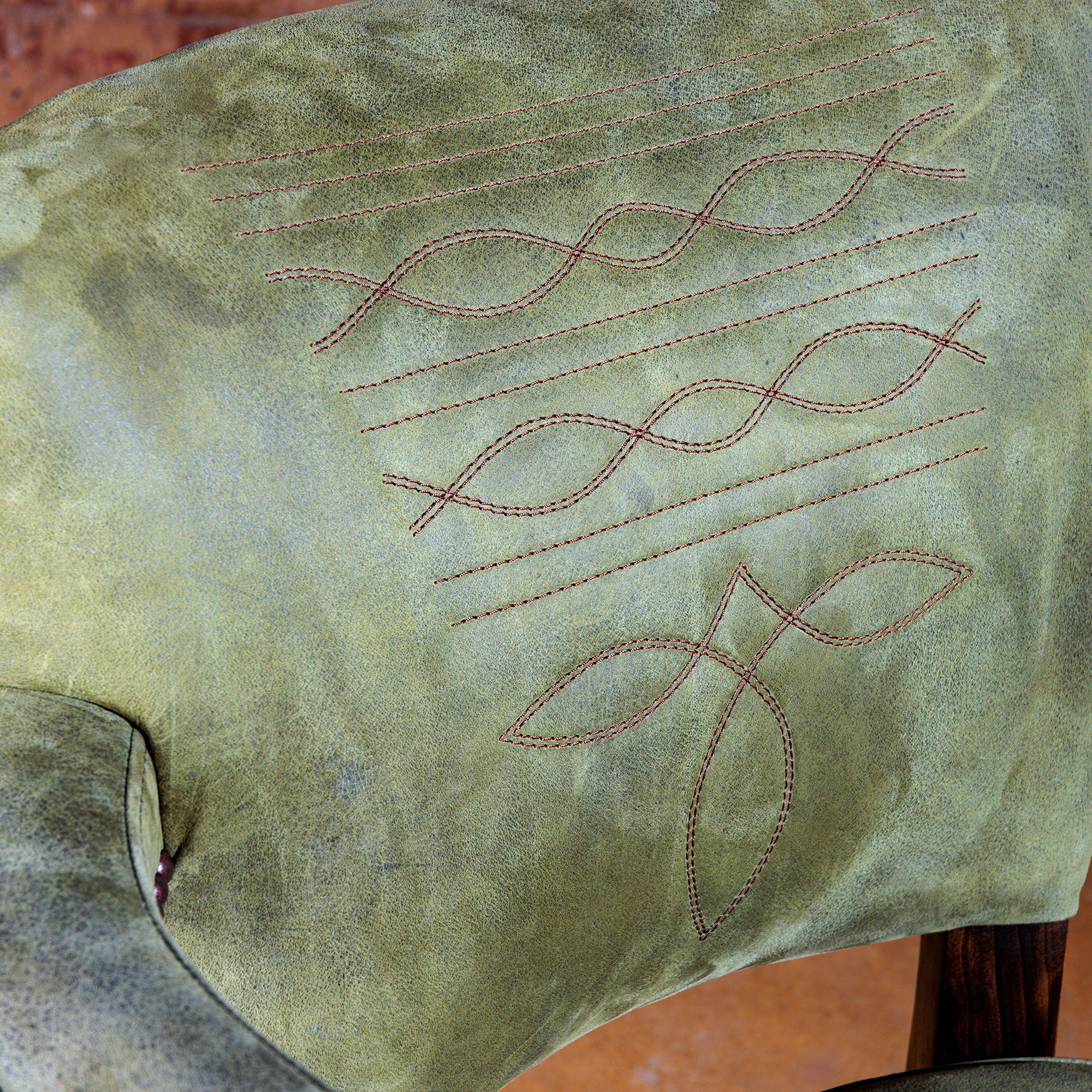 Boot-stitch embroidery detail on sage-green leather backrest—Coronado Western bar stool