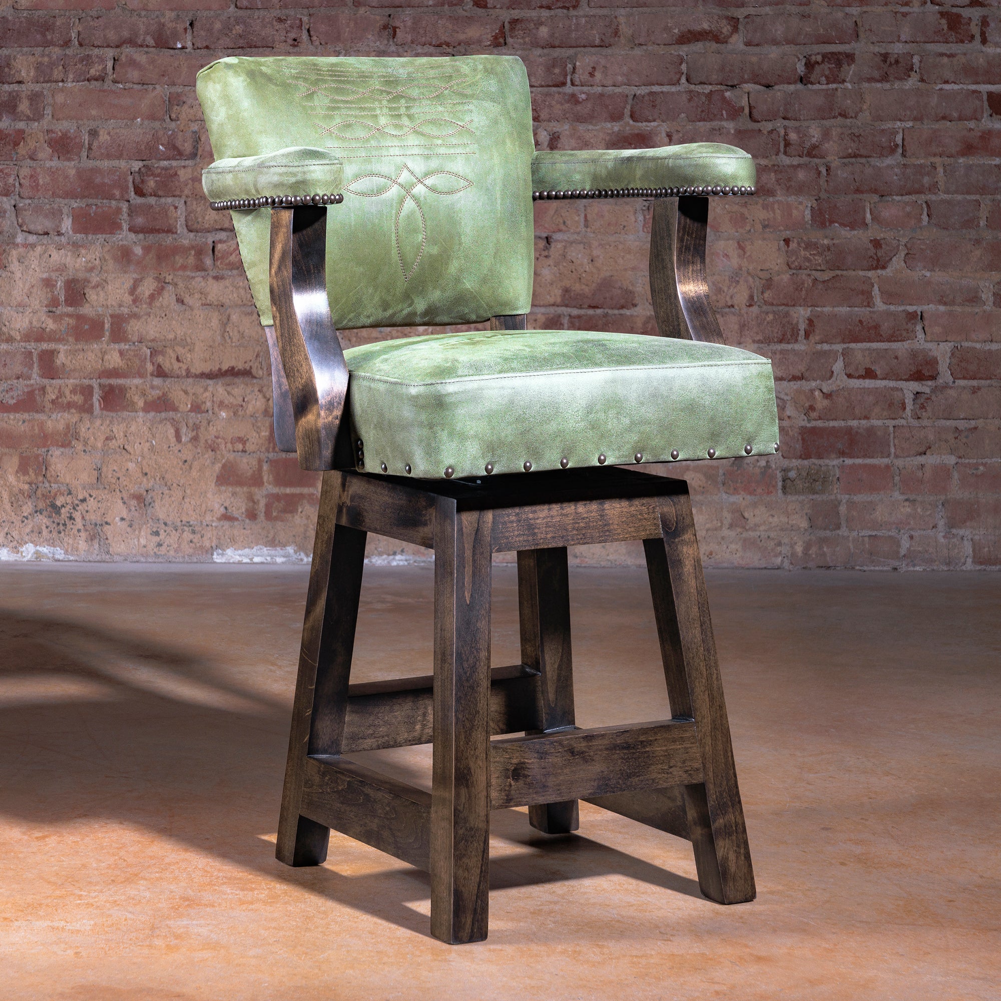 Luxury Western bar stool in sage-green leather with boot-stitch embroidery and axis hide back—Coronado