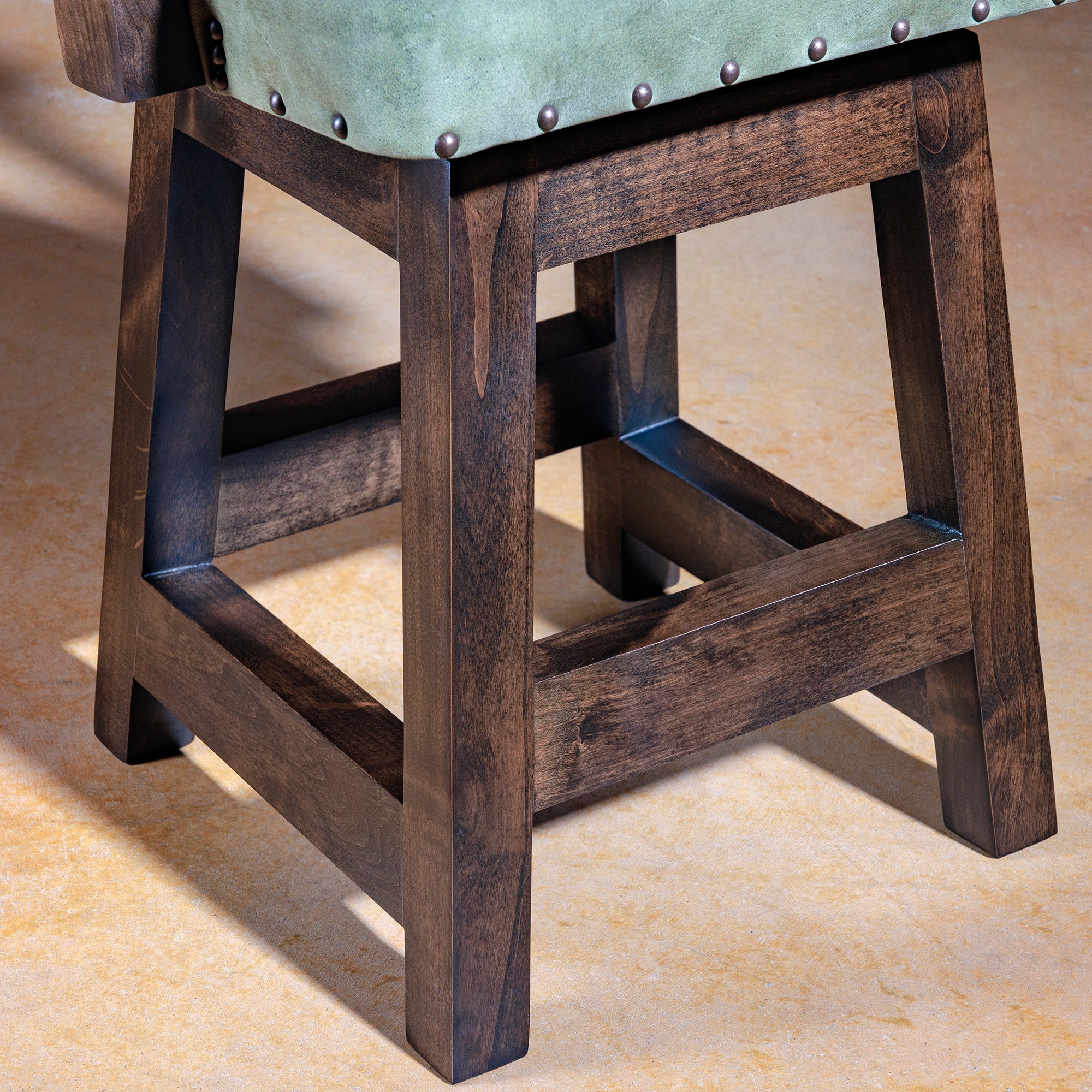 Solid alder wood frame and base detail of Coronado Axis Western bar stool