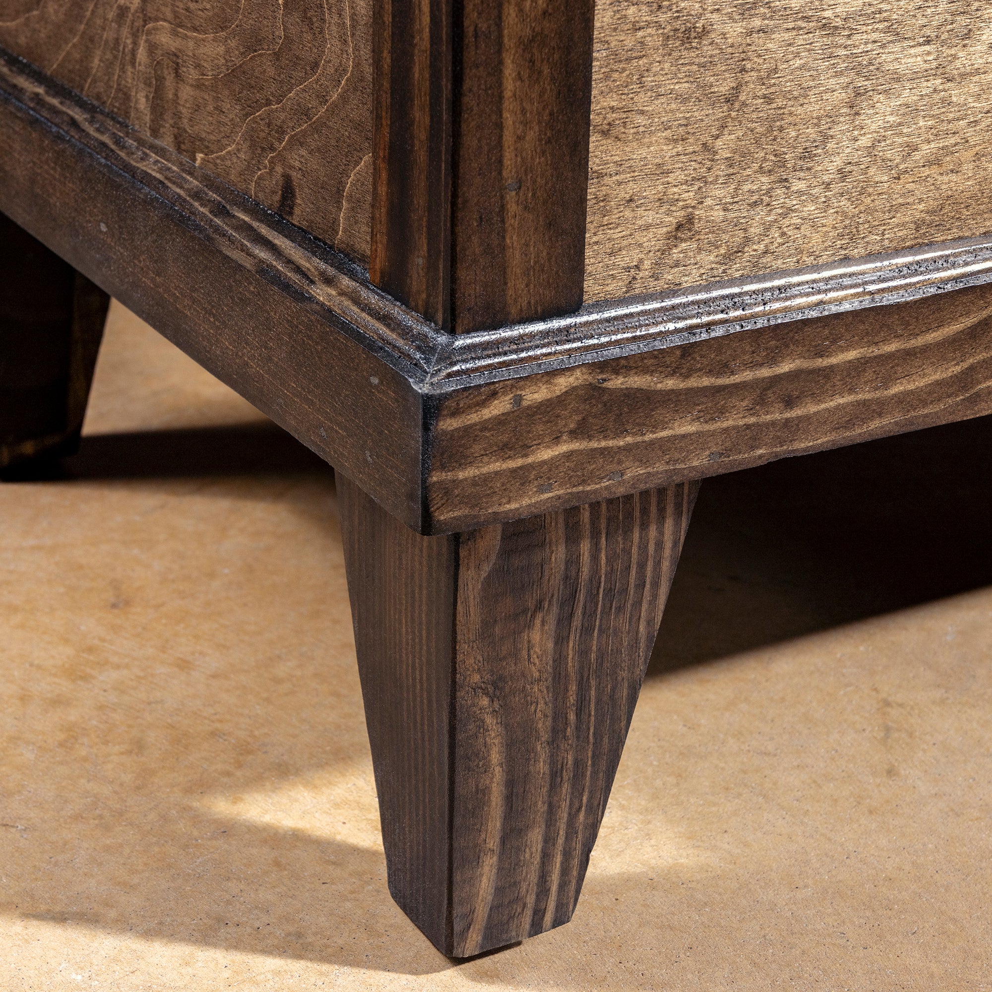 Handcrafted hardwood leg and trim detail on Cattleman’s Hide Storage Bench