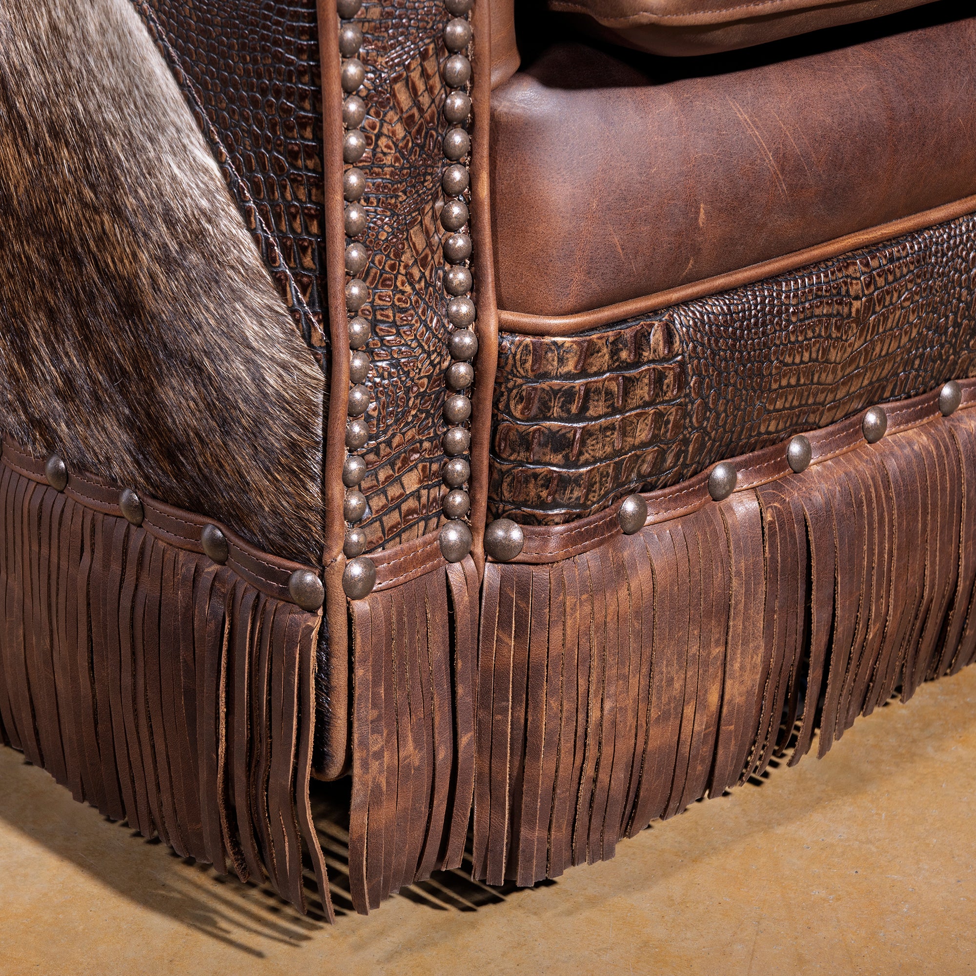 Detail of leather fringe base on Western swivel chair with top-grain leather seat