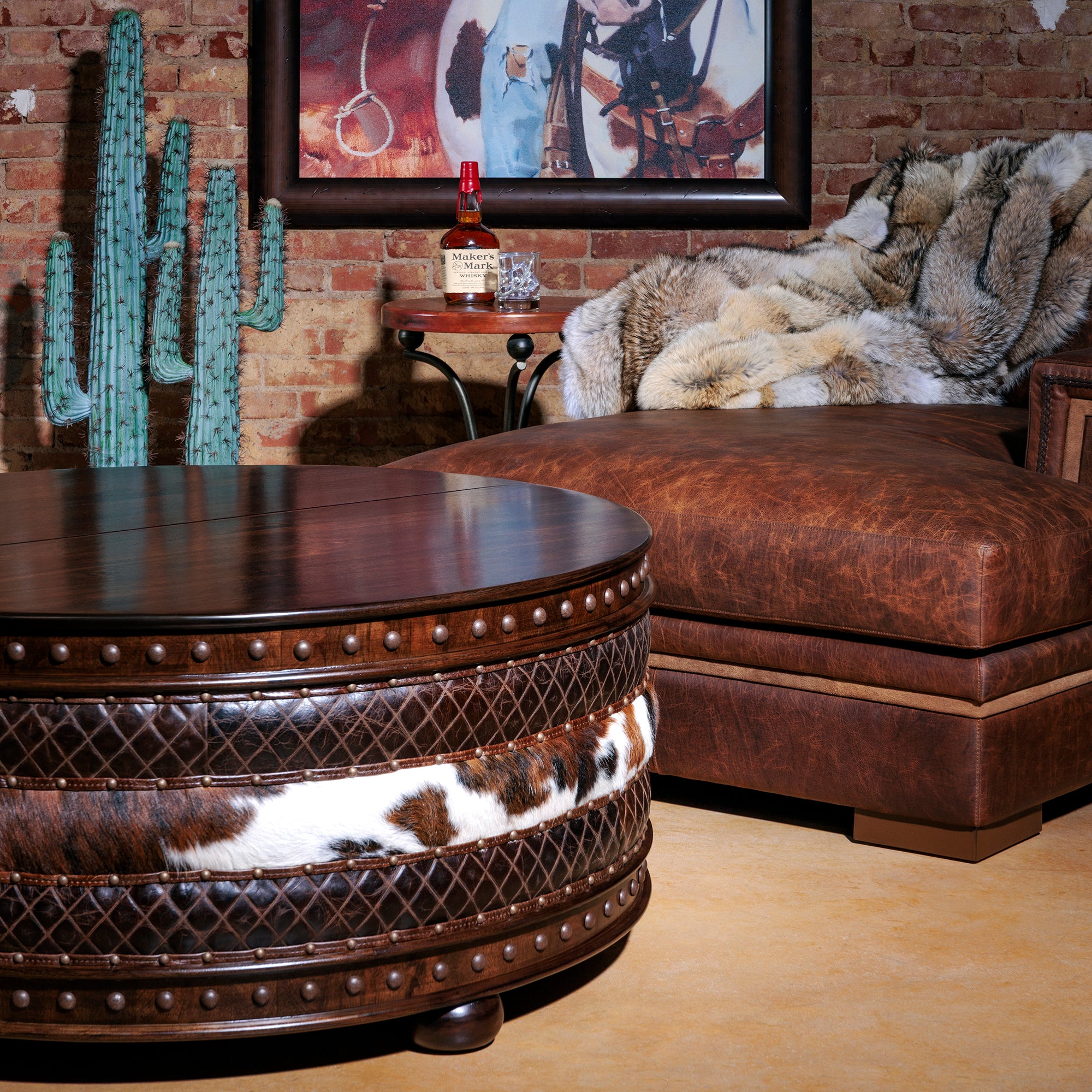 Styled Western living room scene with cowhide coffee table and leather sectional