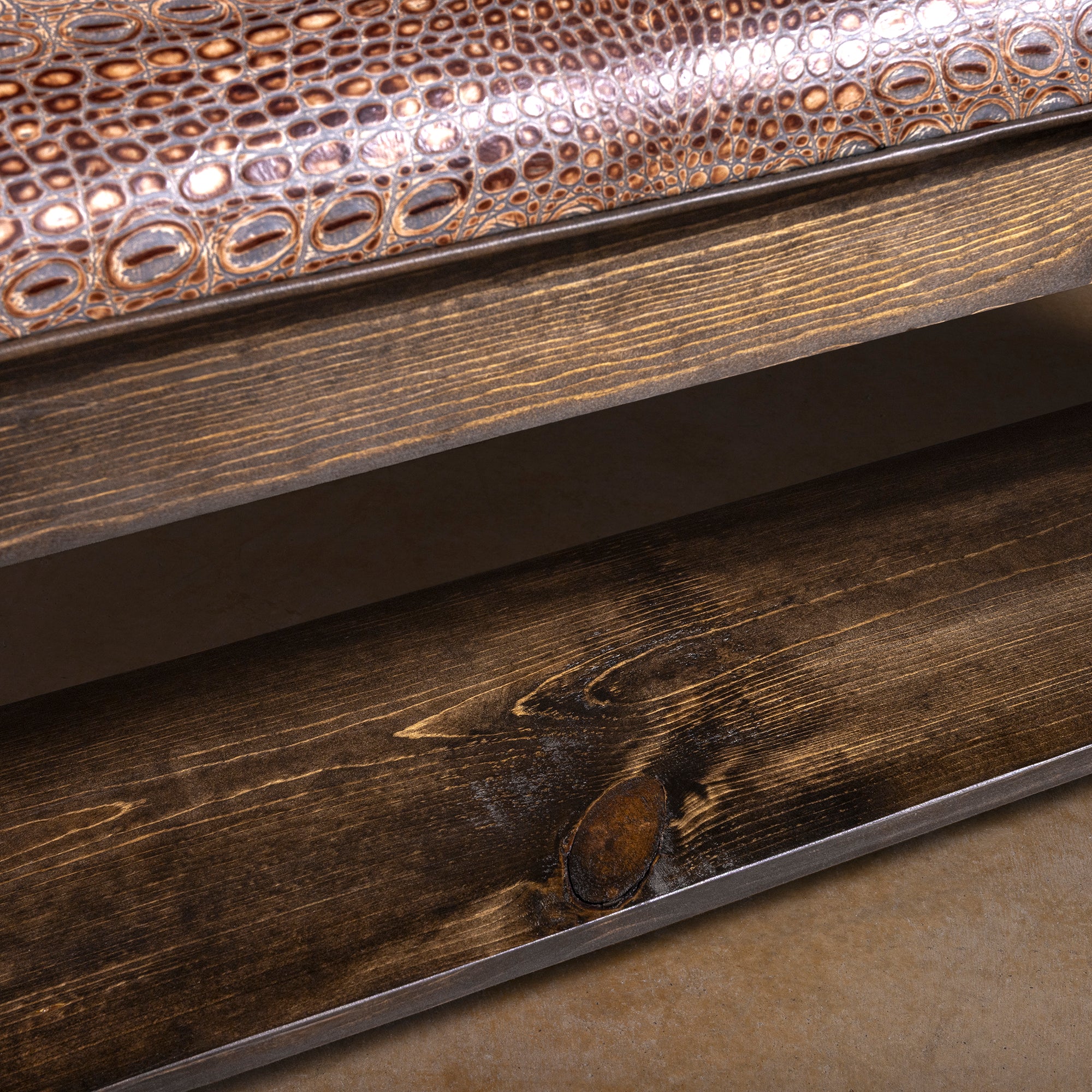 Estancia Regent Embossed Leather Western Bench western bench close-up showing lower shelf, dark wood grain, and leather seat detail