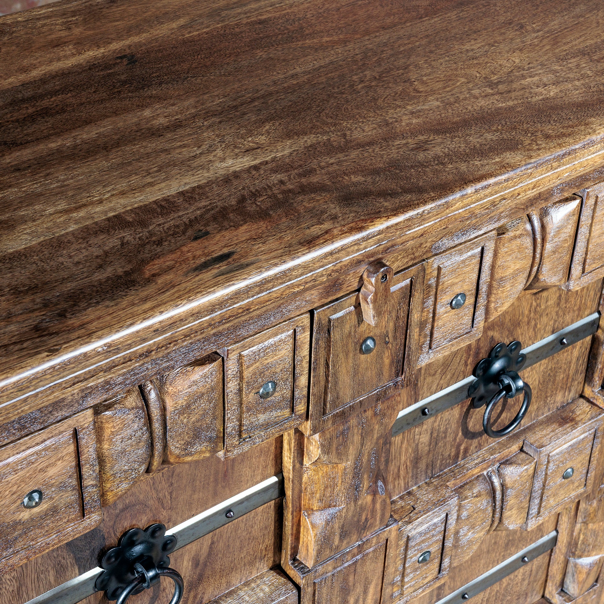 Detailed look at wood grain and ironwork on the buffet’s surface
