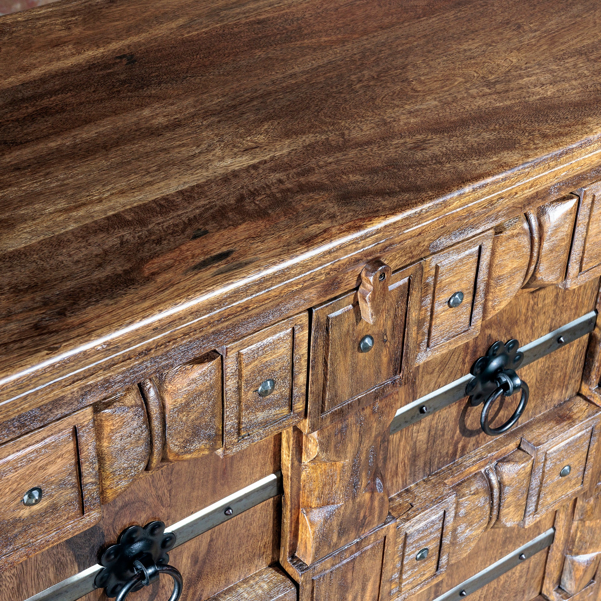 Solid mango wood top and carved front panel detail of the Hacienda Ironwood Buffet