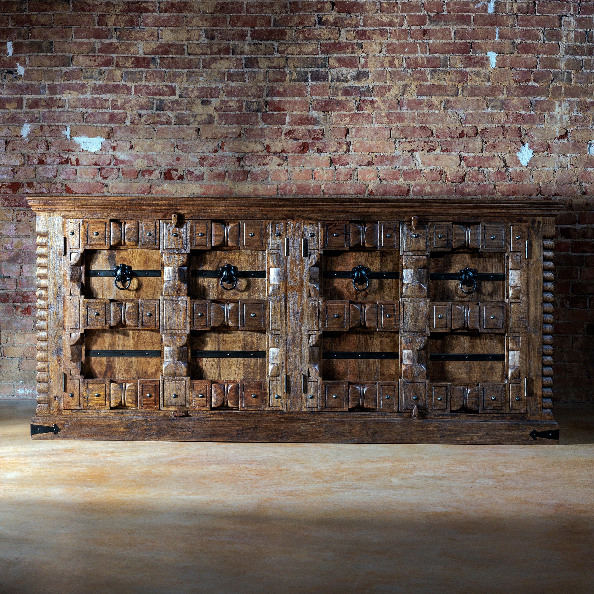 Rustic buffet sideboard with iron accents and carved wood detail