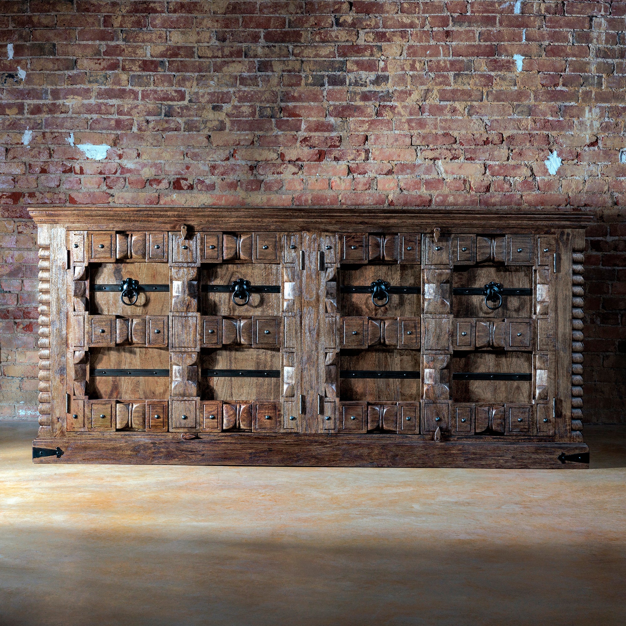 Full front view of the Hacienda Ironwood Buffet with Spanish-style carvings and iron strapping