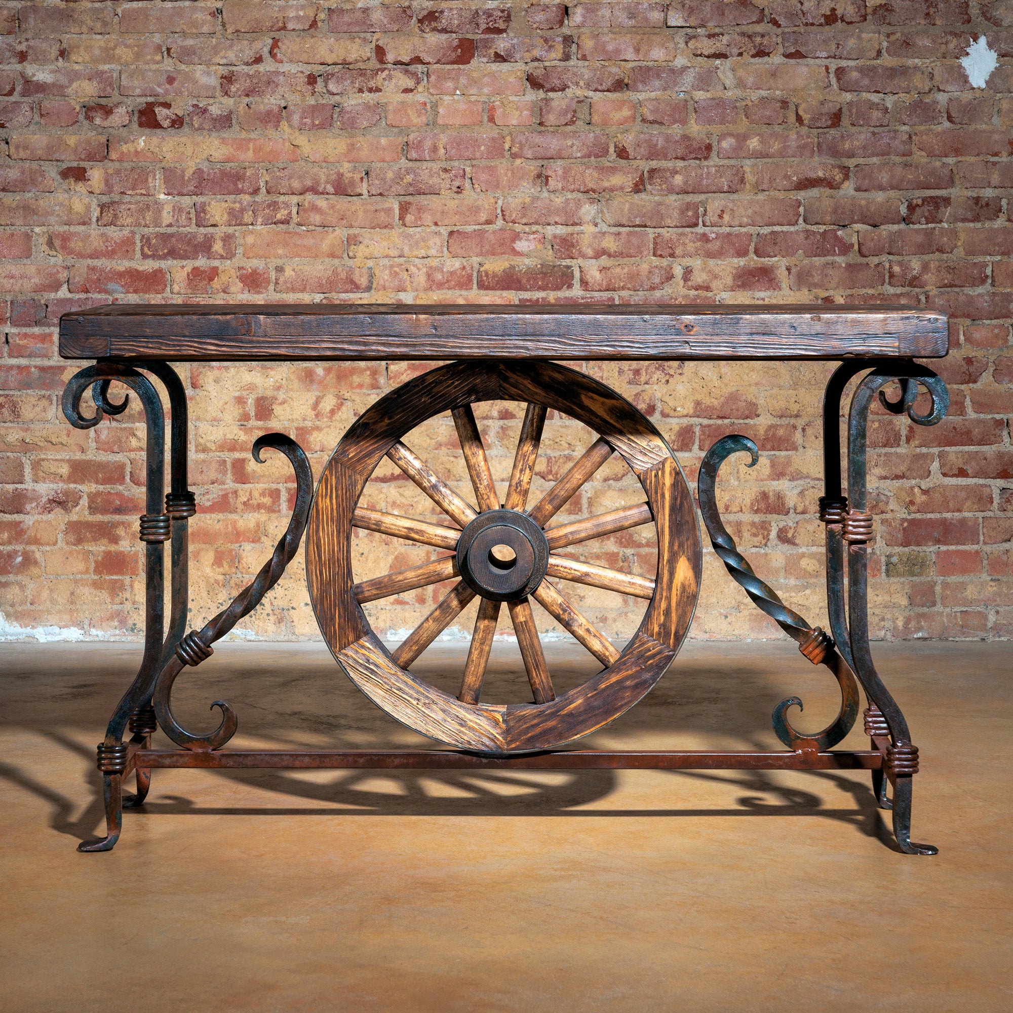 Hero image of rustic Western console table with wagon wheel and iron legs