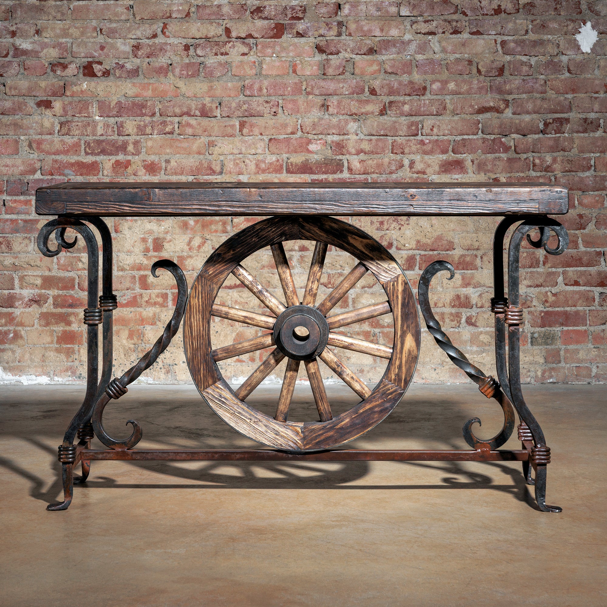 Hero image of rustic Western console table with wagon wheel and iron legs