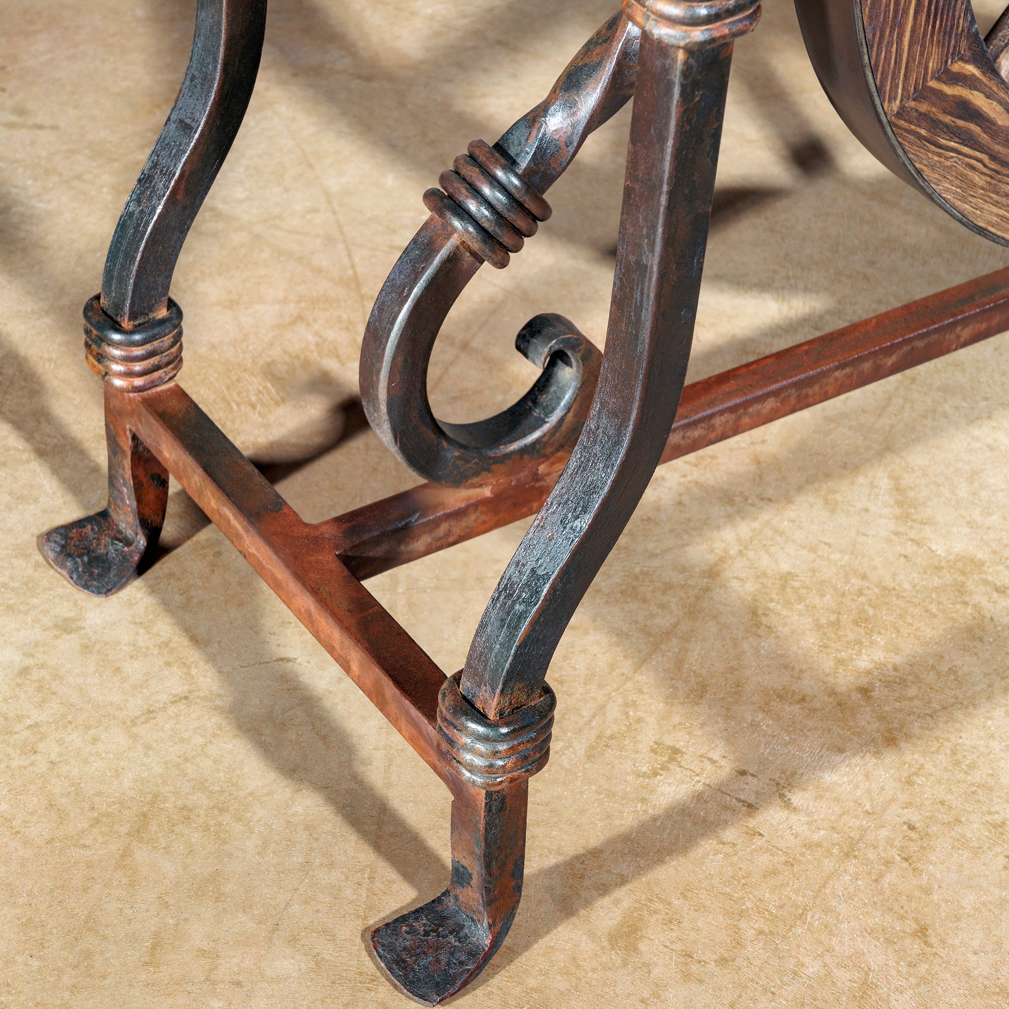 Detail of forged iron leg with scroll design