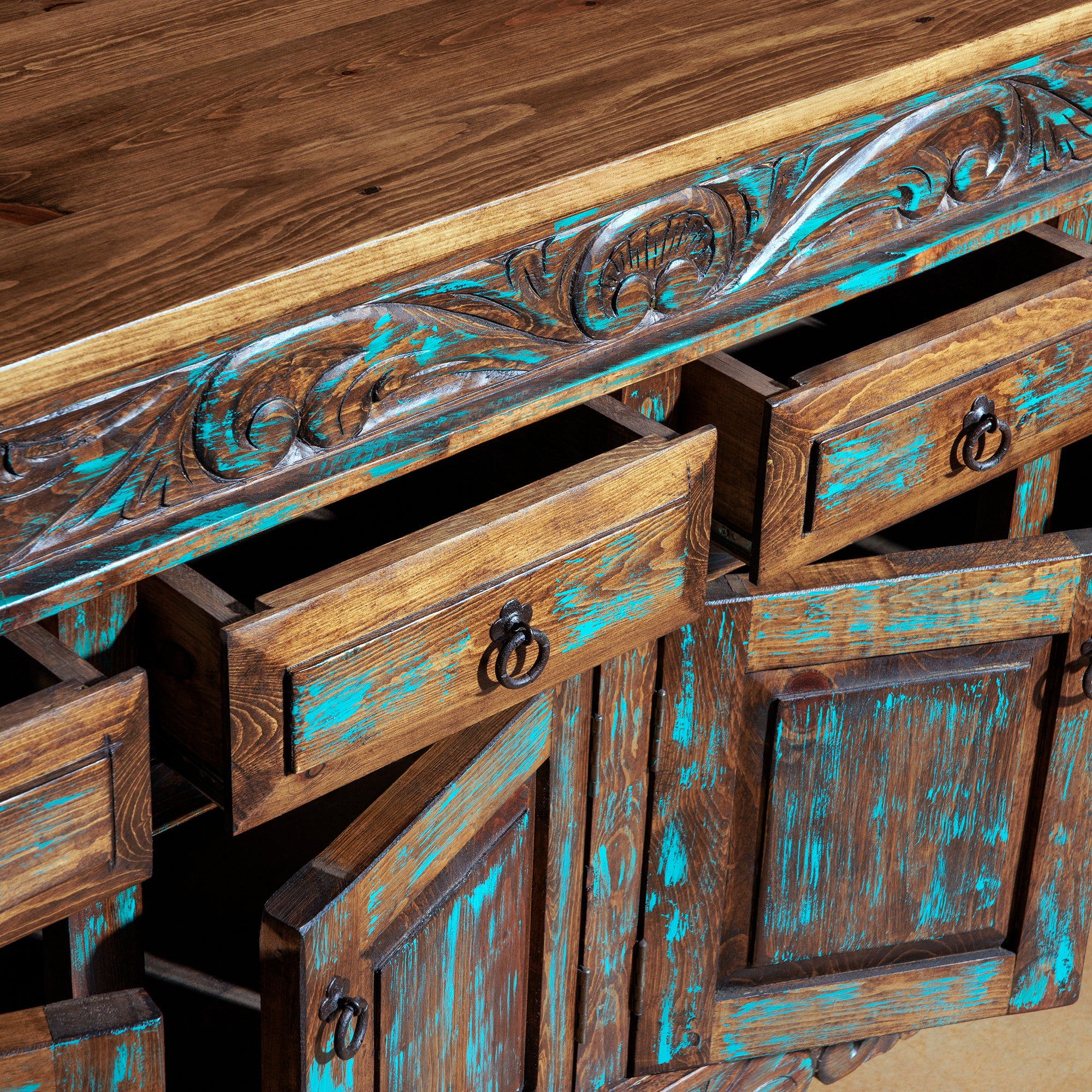 Open drawers and cabinet detail of hand-carved Western turquoise buffet