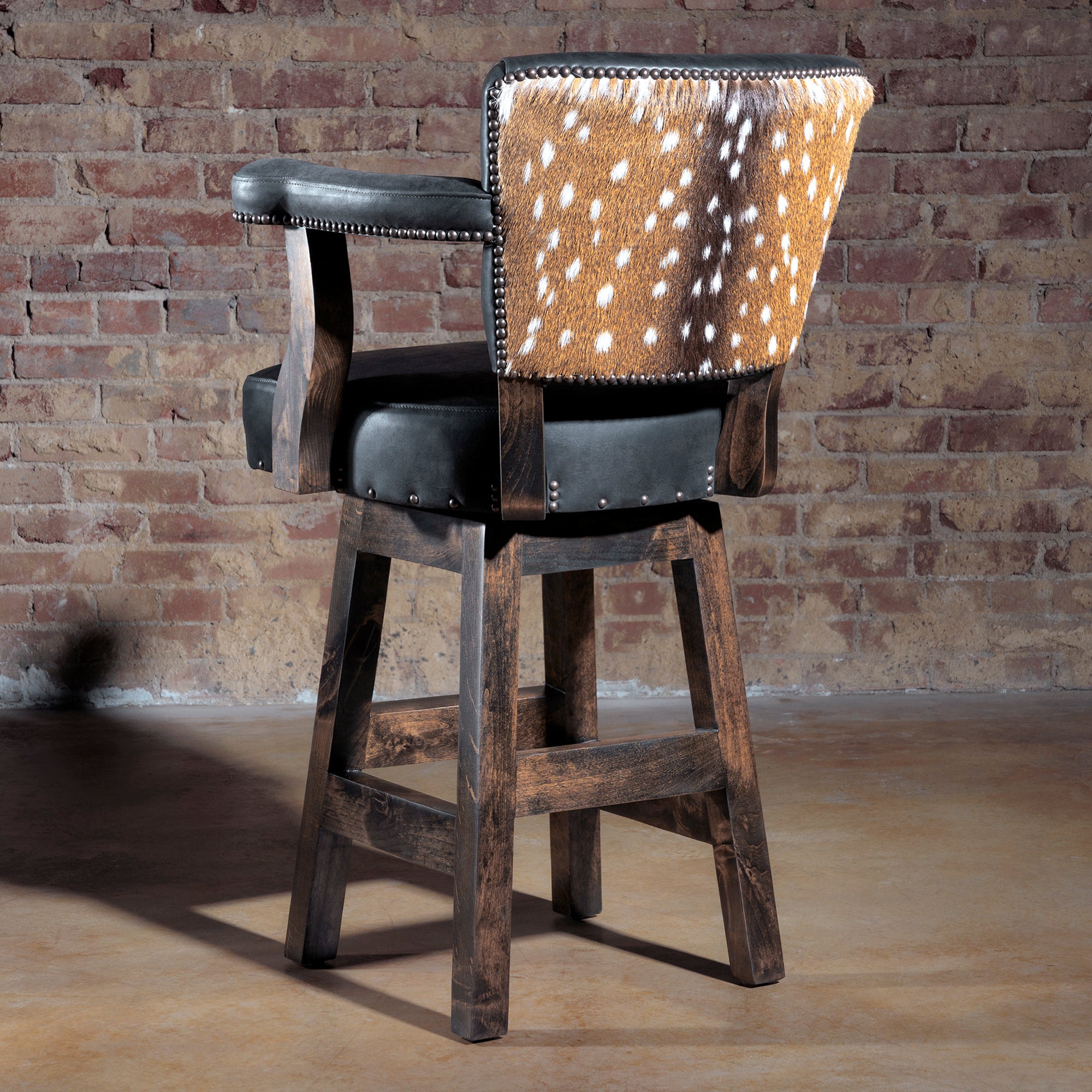 Rear view of luxury bar stool showing axis hide backrest with nailhead trim.