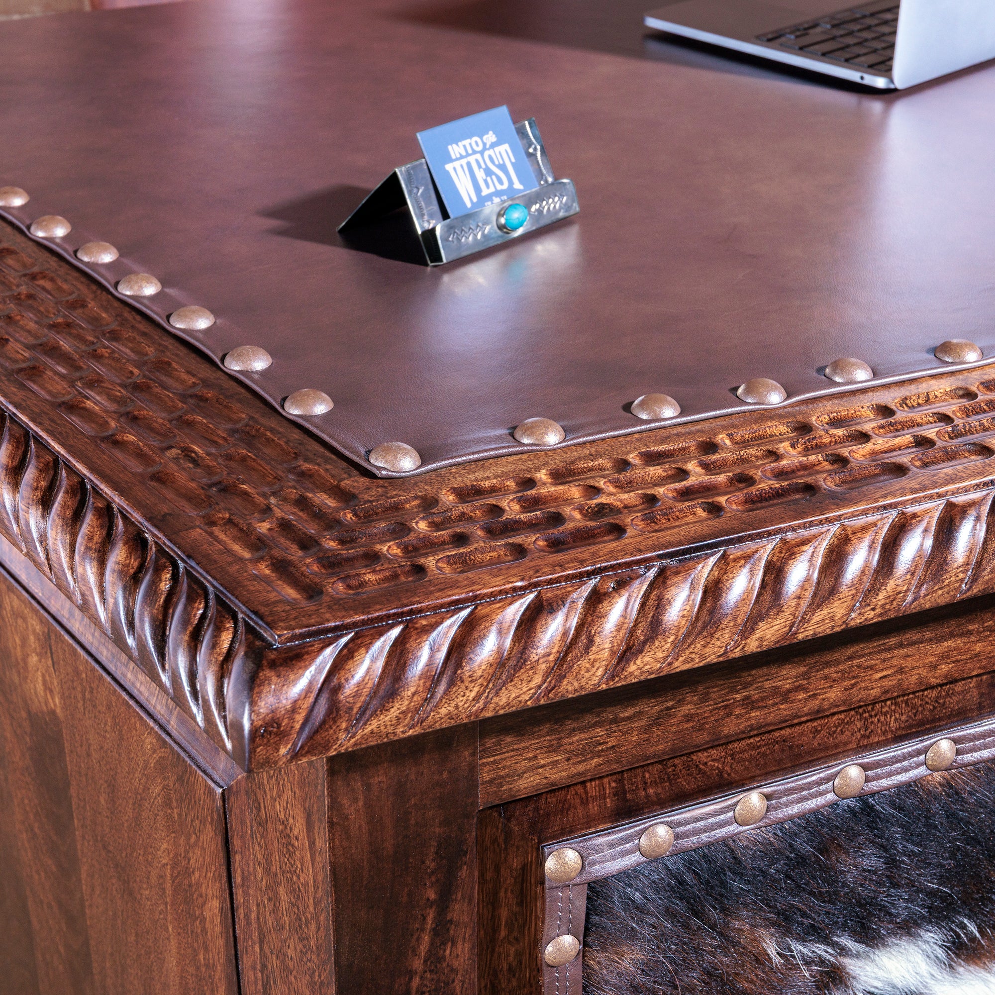 Leather writing surface with tooled wood trim on High Plains Western desk