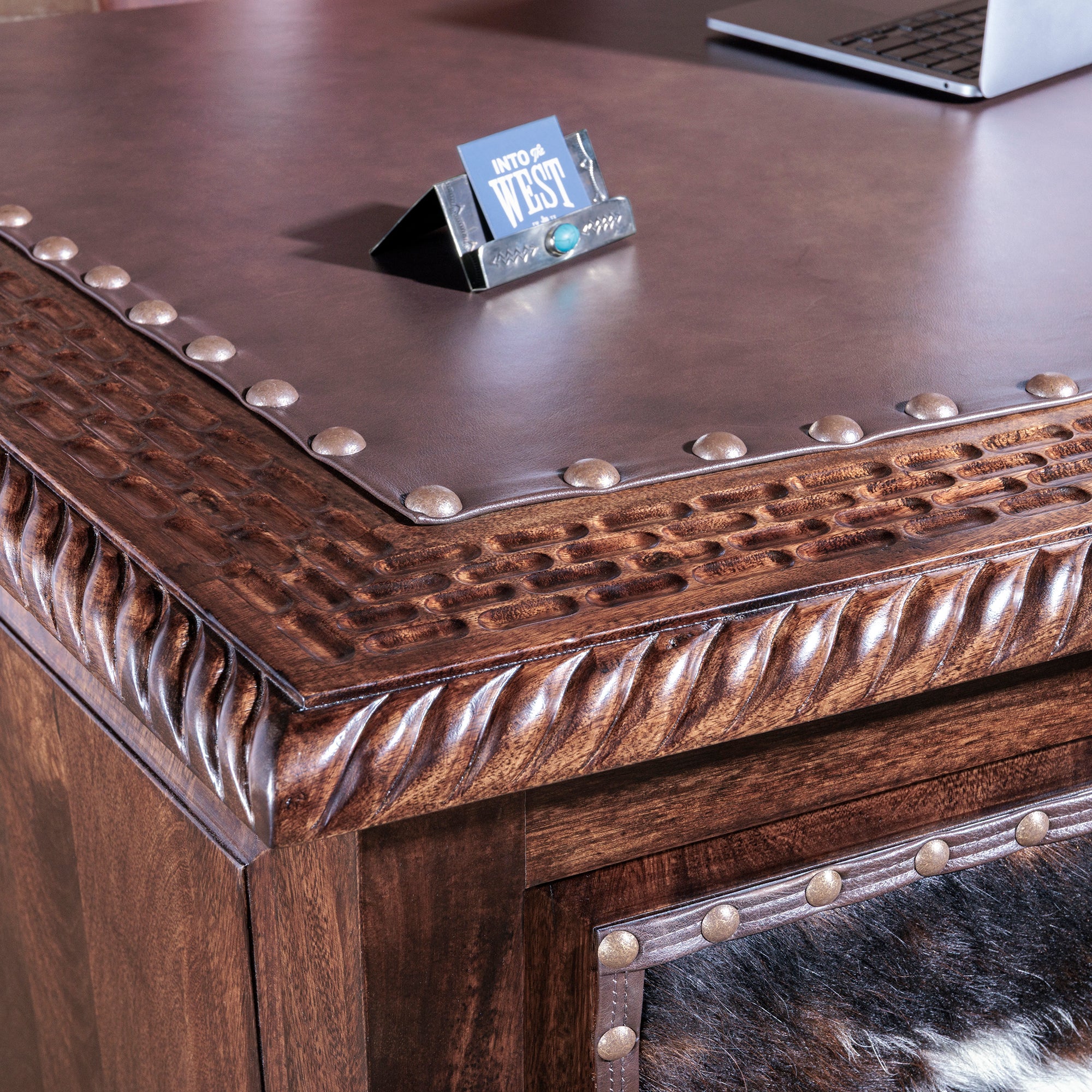 Leather writing surface with tooled wood trim on High Plains Western desk