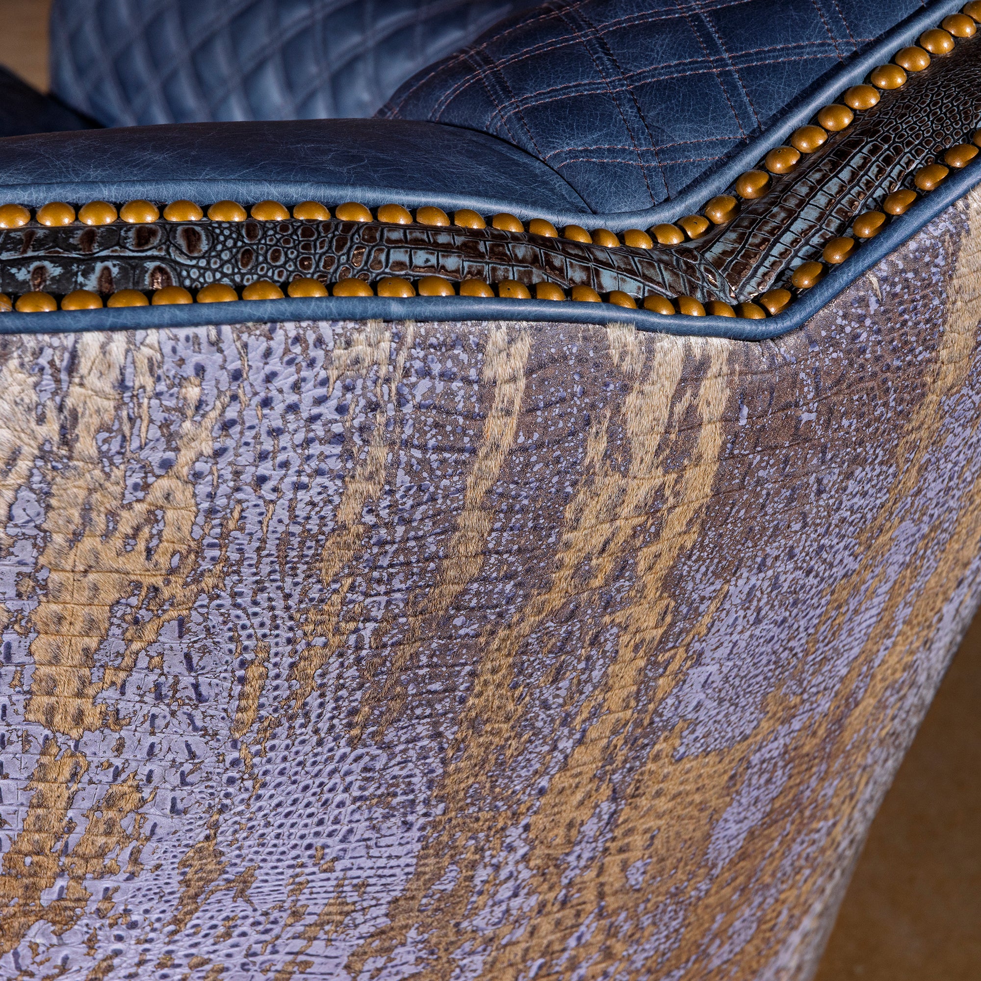 Close-up of acid-washed cowhide texture on Indigo Canyon swivel chair back