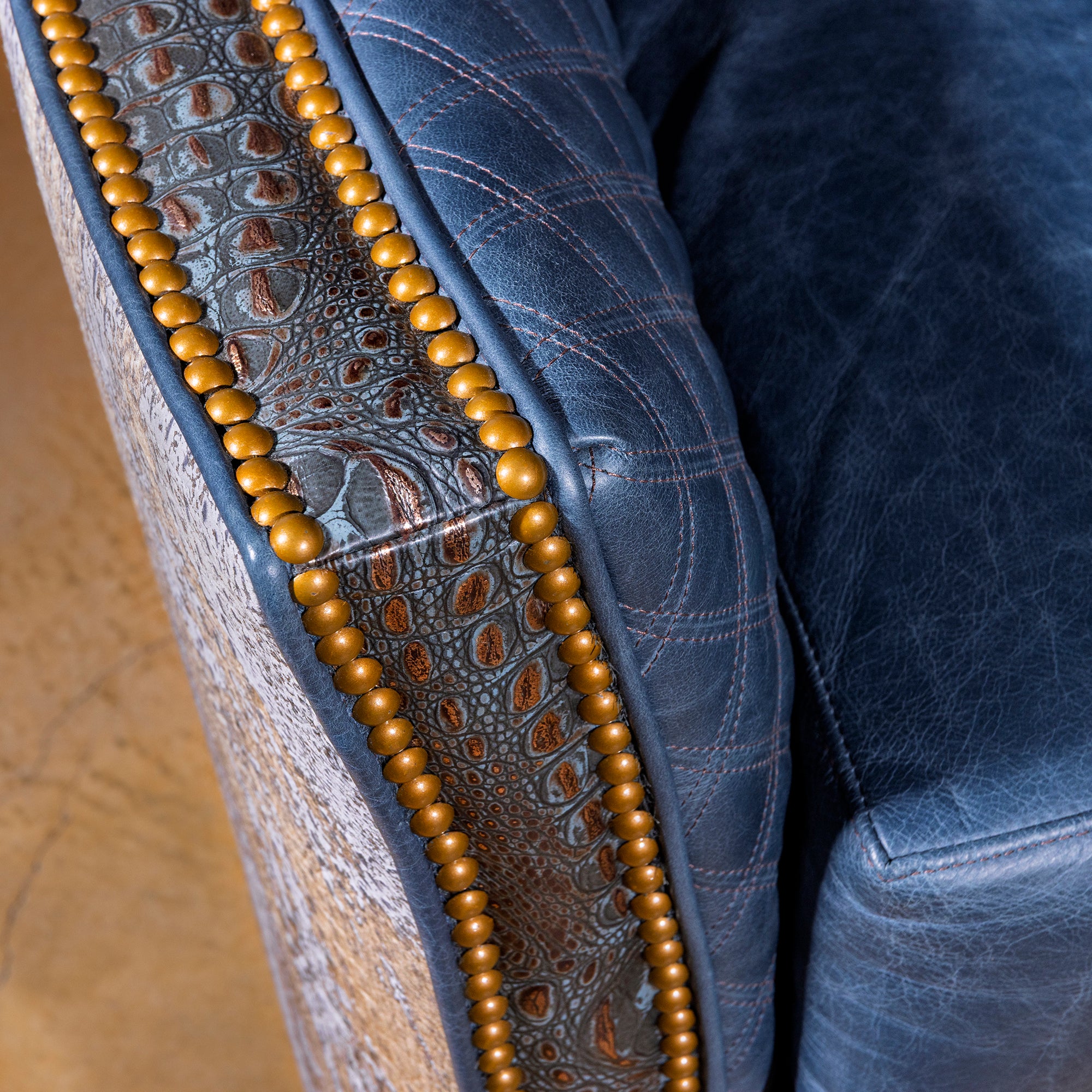 Croc-embossed leather trim with brass-toned nailheads on Indigo Canyon chair