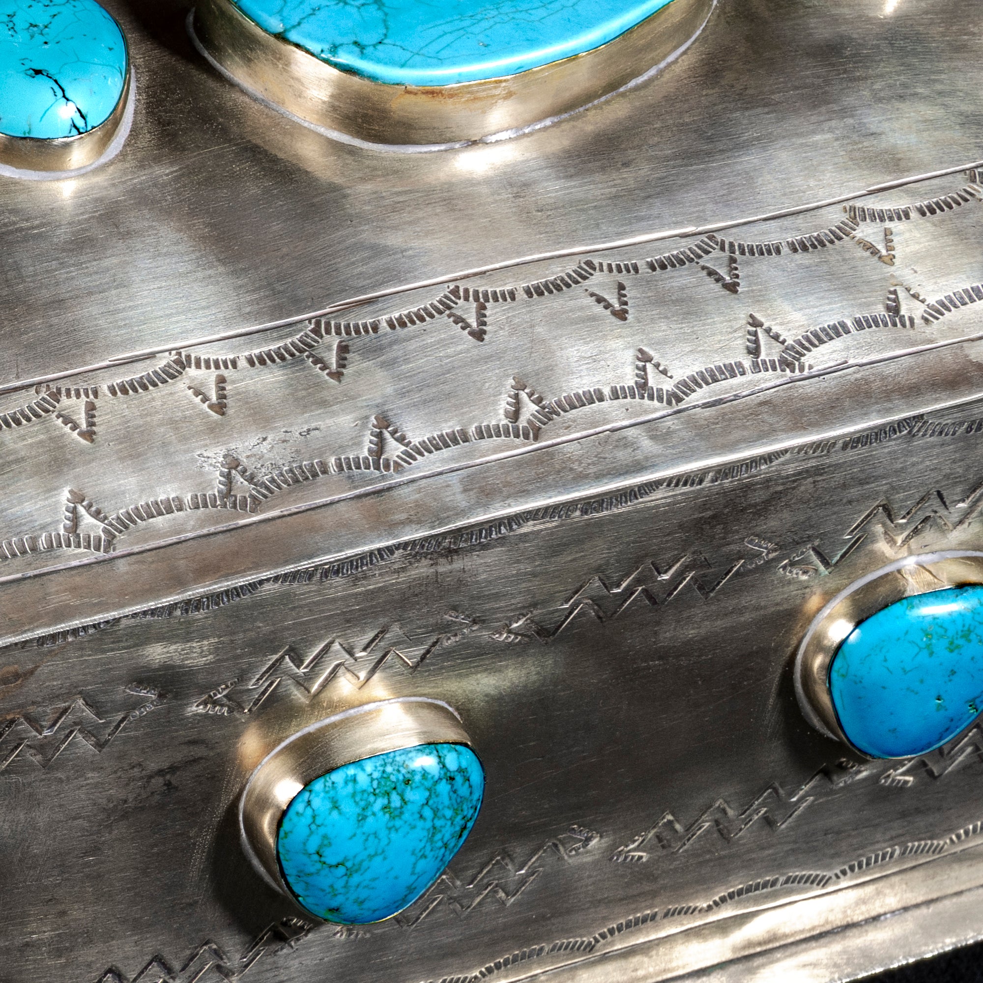 Side view of Western-stamped German silver with turquoise inlay craftsmanship by J. Alexander