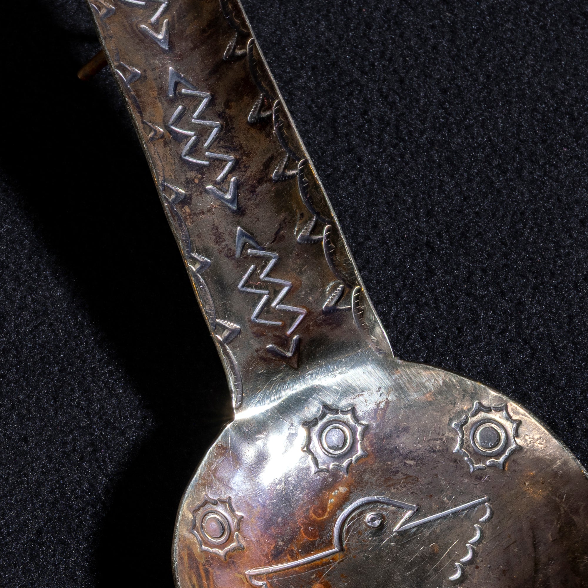 Detailed view of lightning pattern stamp on hand-forged German silver cigar rest handle