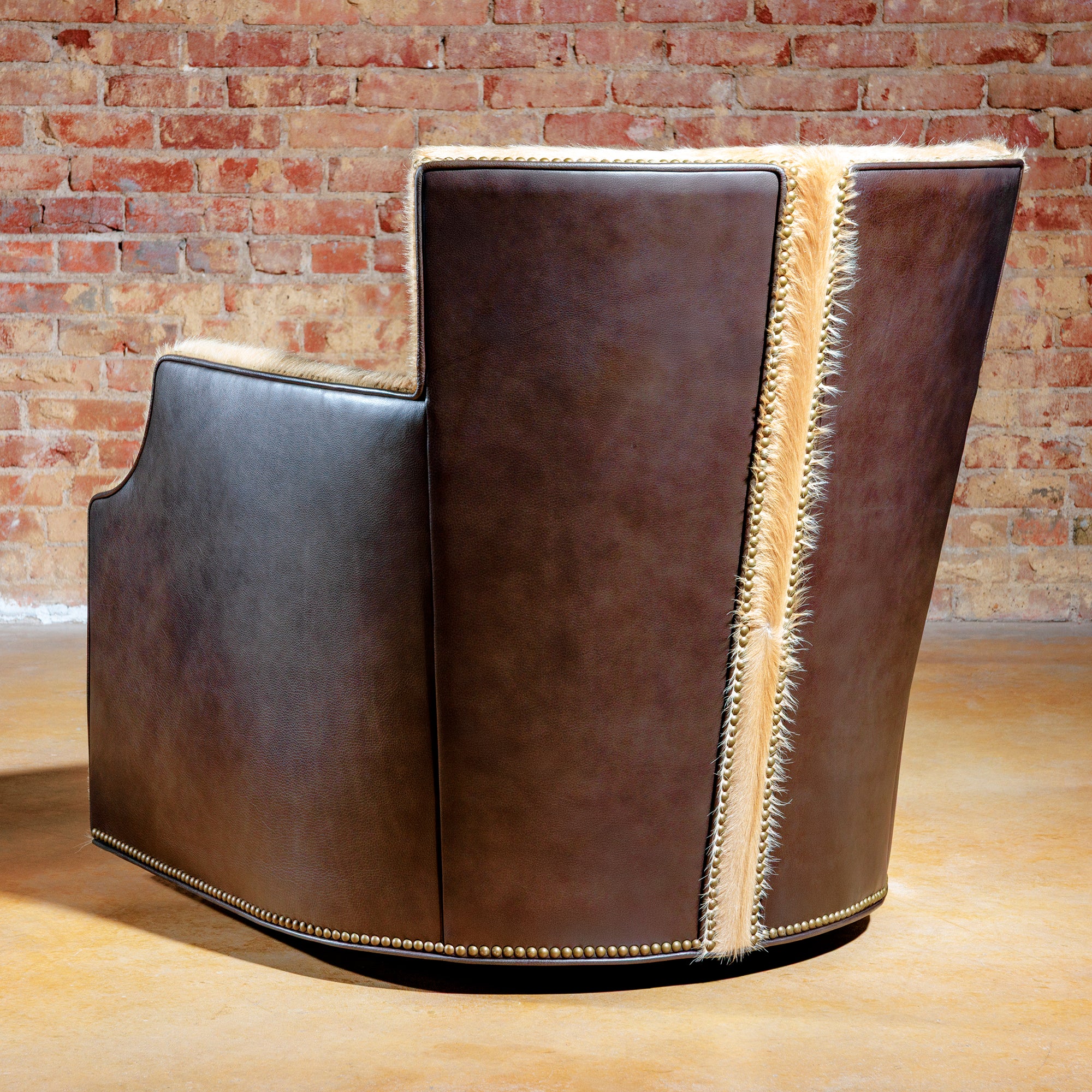 Rear view of leather swivel chair with light axis hide accent