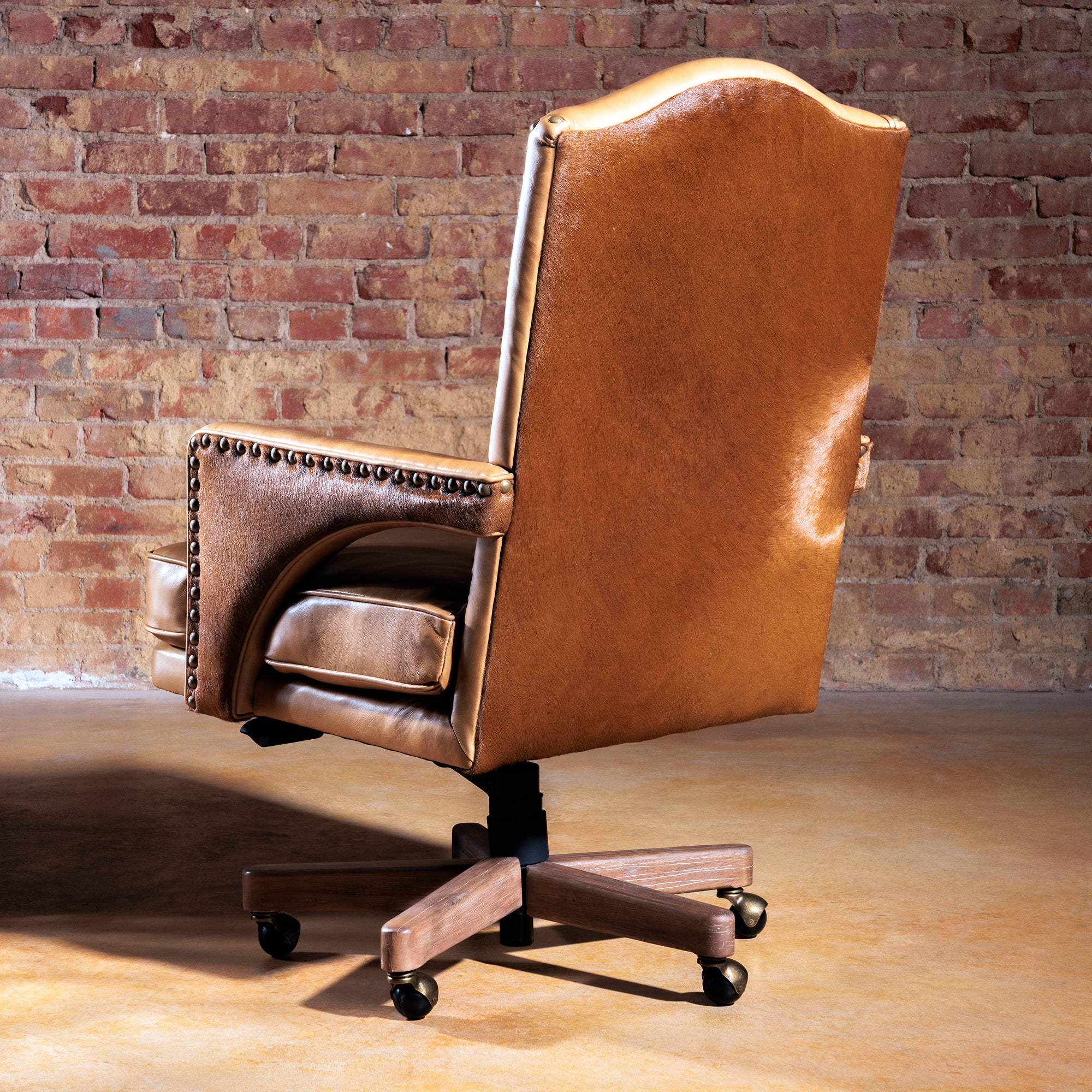 Back view of Western-style leather and cowhide desk chair with arched top