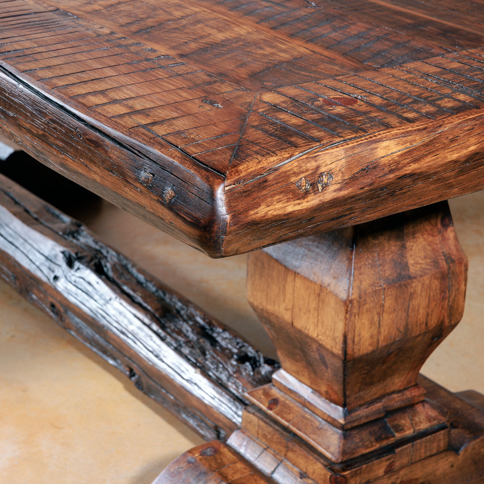 Distressed tabletop corner highlighting reclaimed wood craftsmanship.