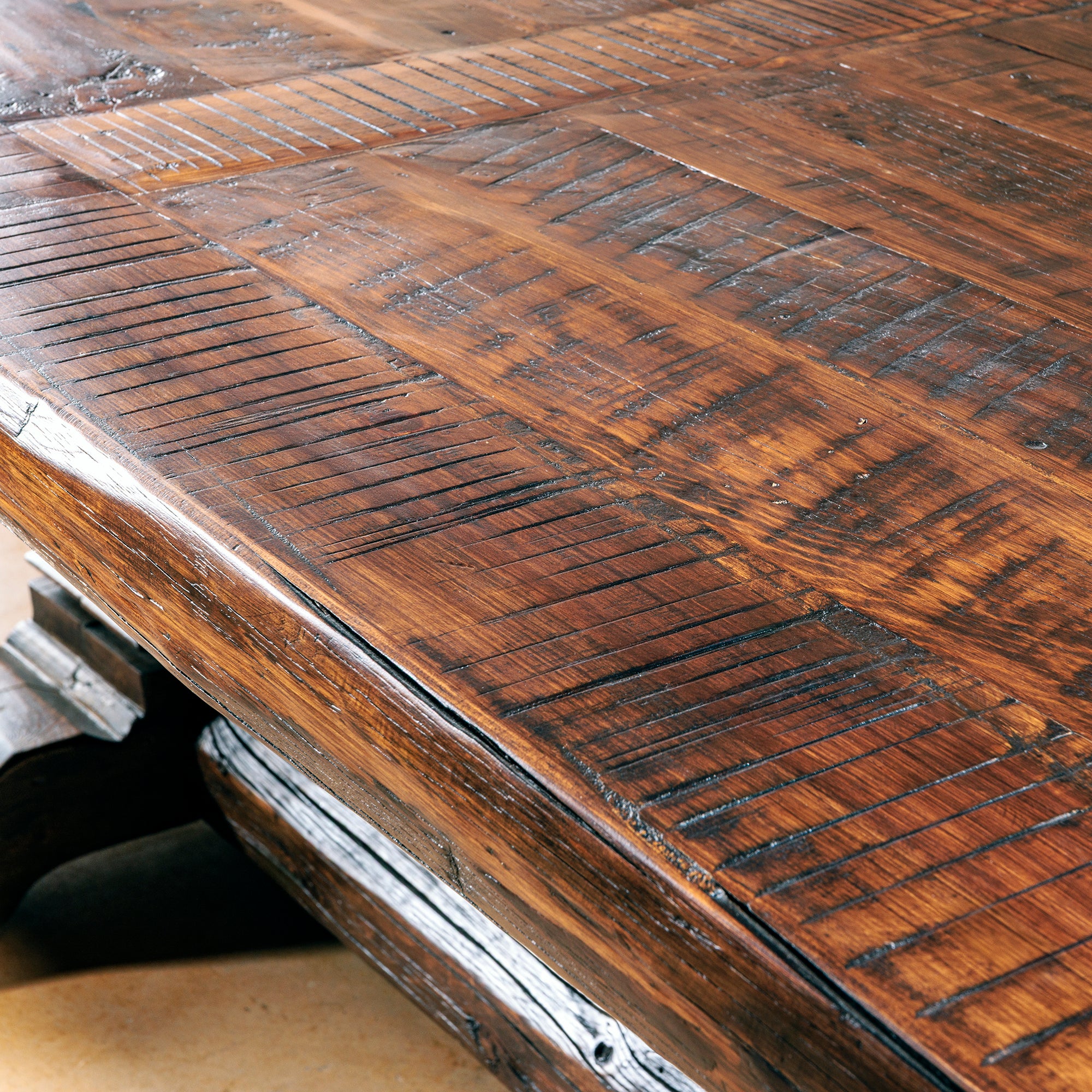 Close-up of hand-finished tabletop with saw marks and natural patina.