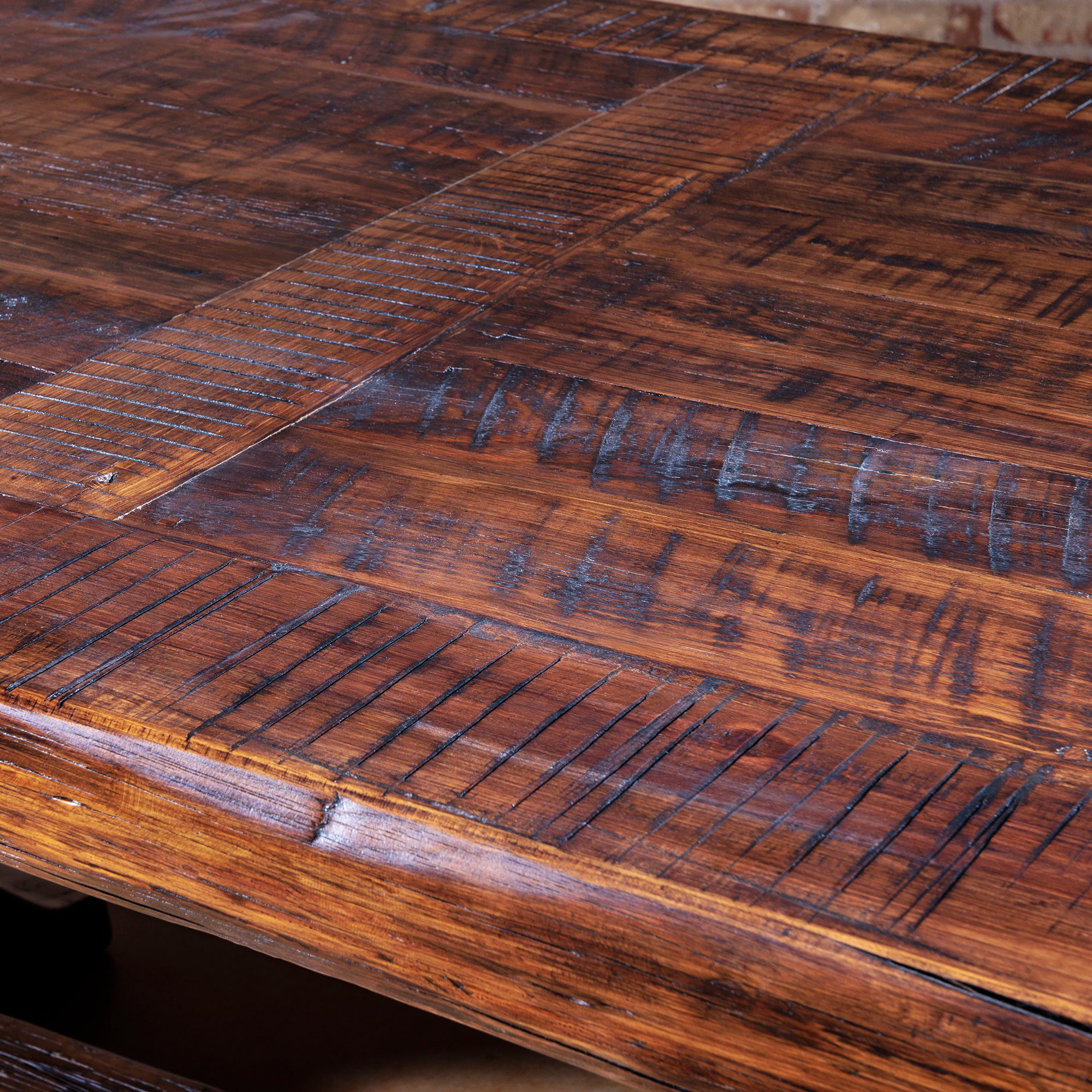 Close-up of hand-finished tabletop with saw marks and natural patina.