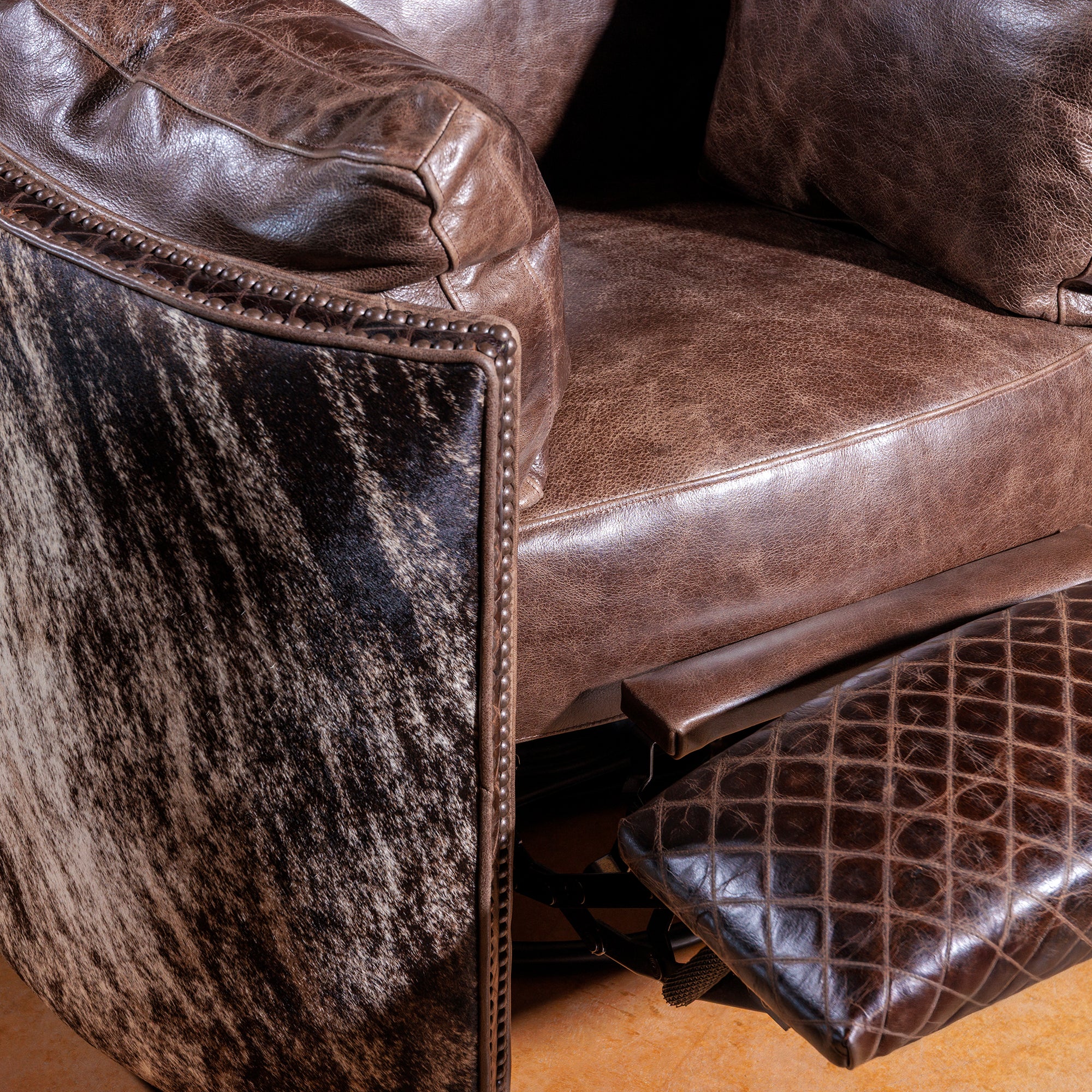 Close-up of top-grain leather and antique nailhead detailing on Western recliner