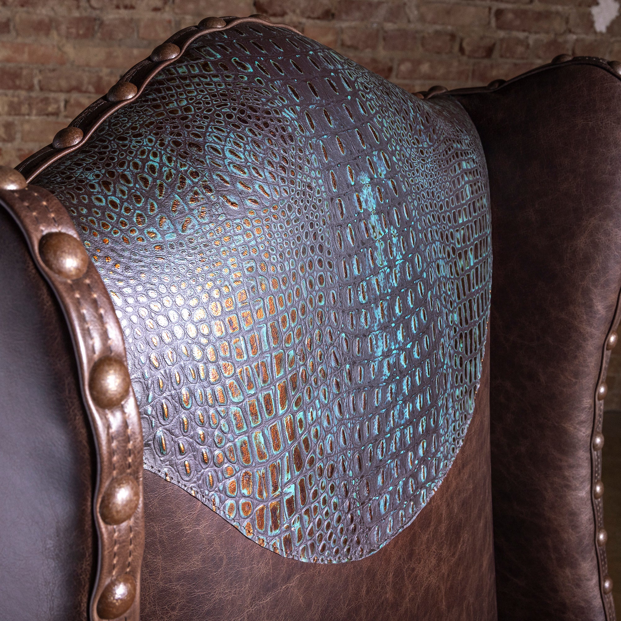 Croc-embossed leather yoke detail on high-back Western desk chair with turquoise copper patina finish