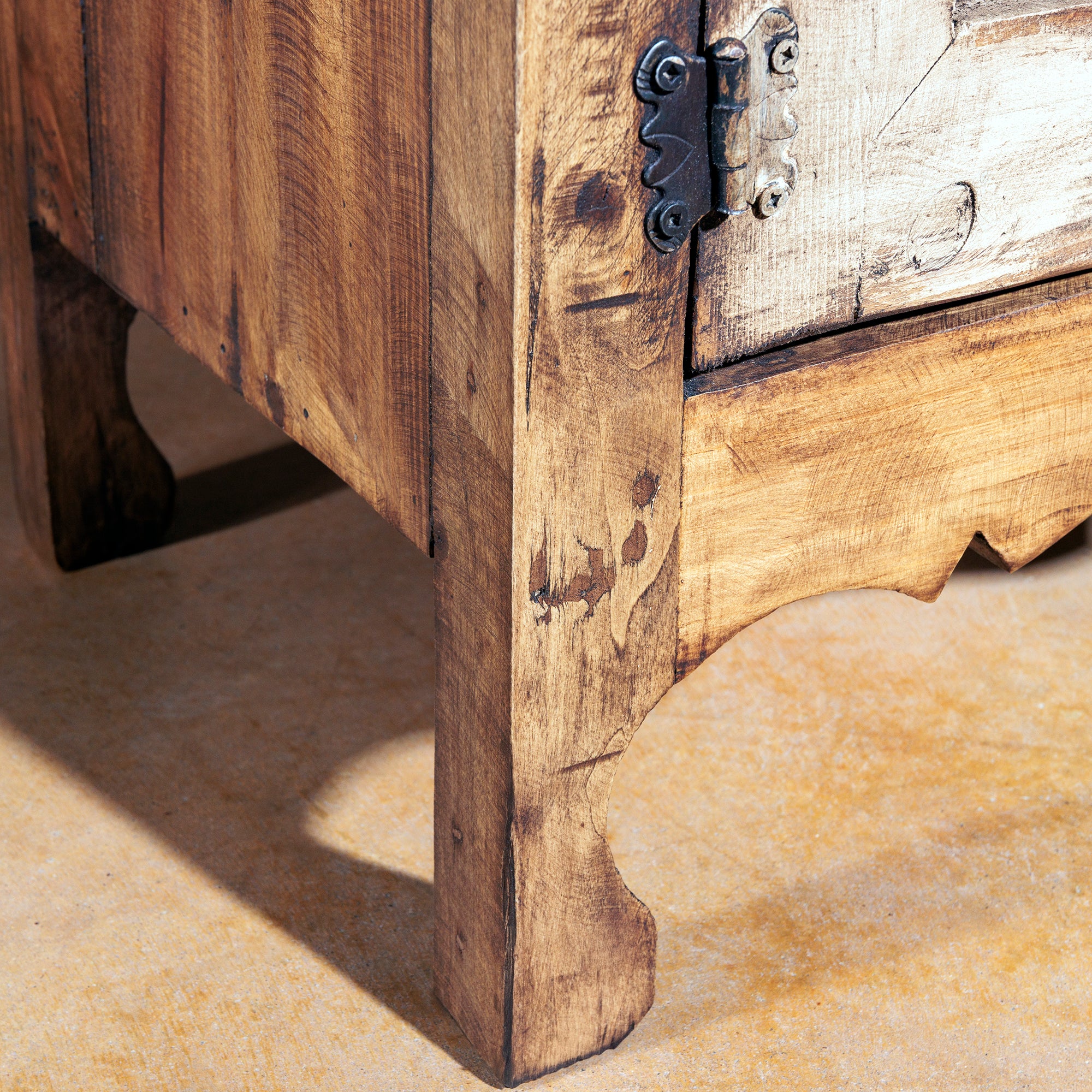 Leg detail with carved apron and distressed wood texture