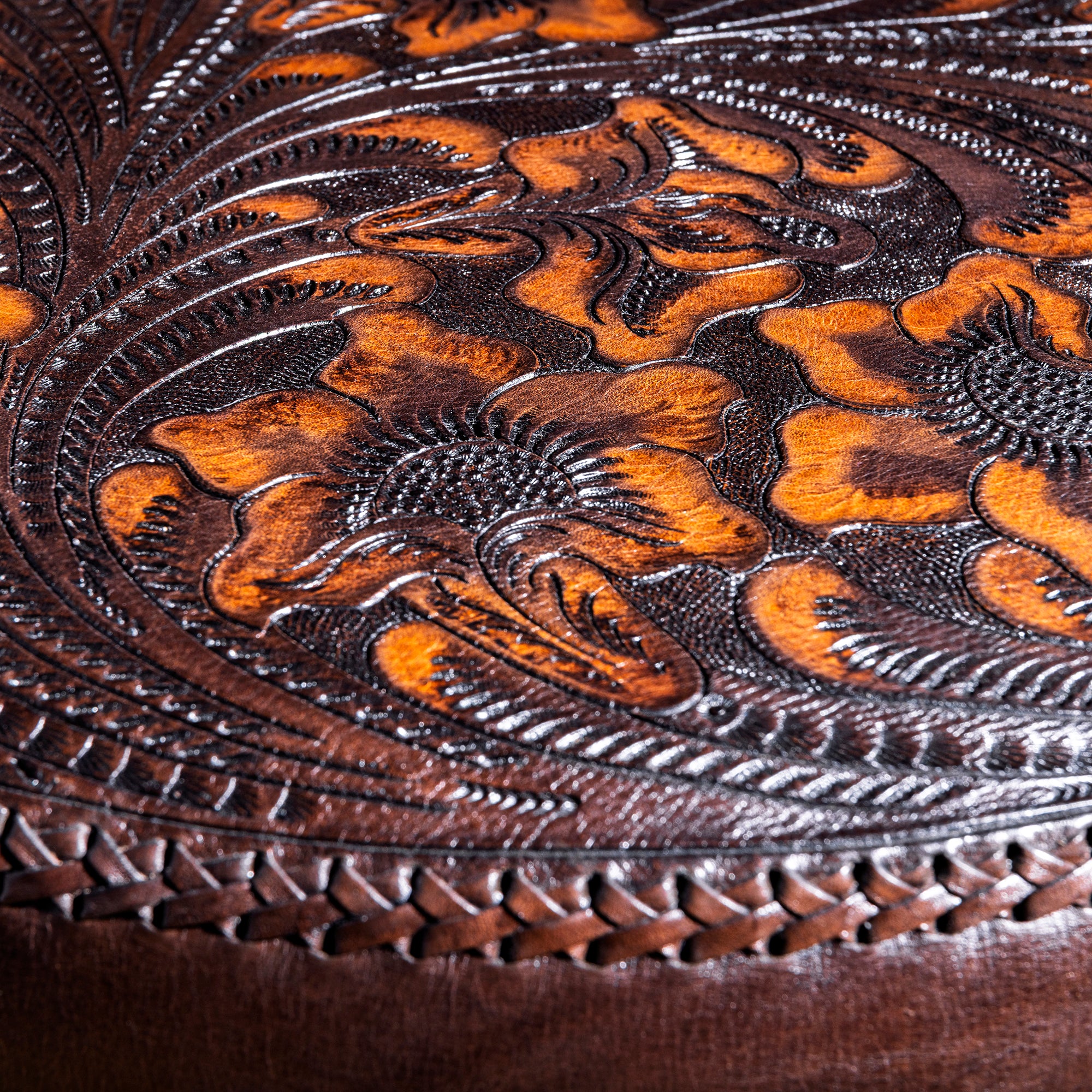 Close-up of tooled floral top-grain leather on Western fringe ottoman