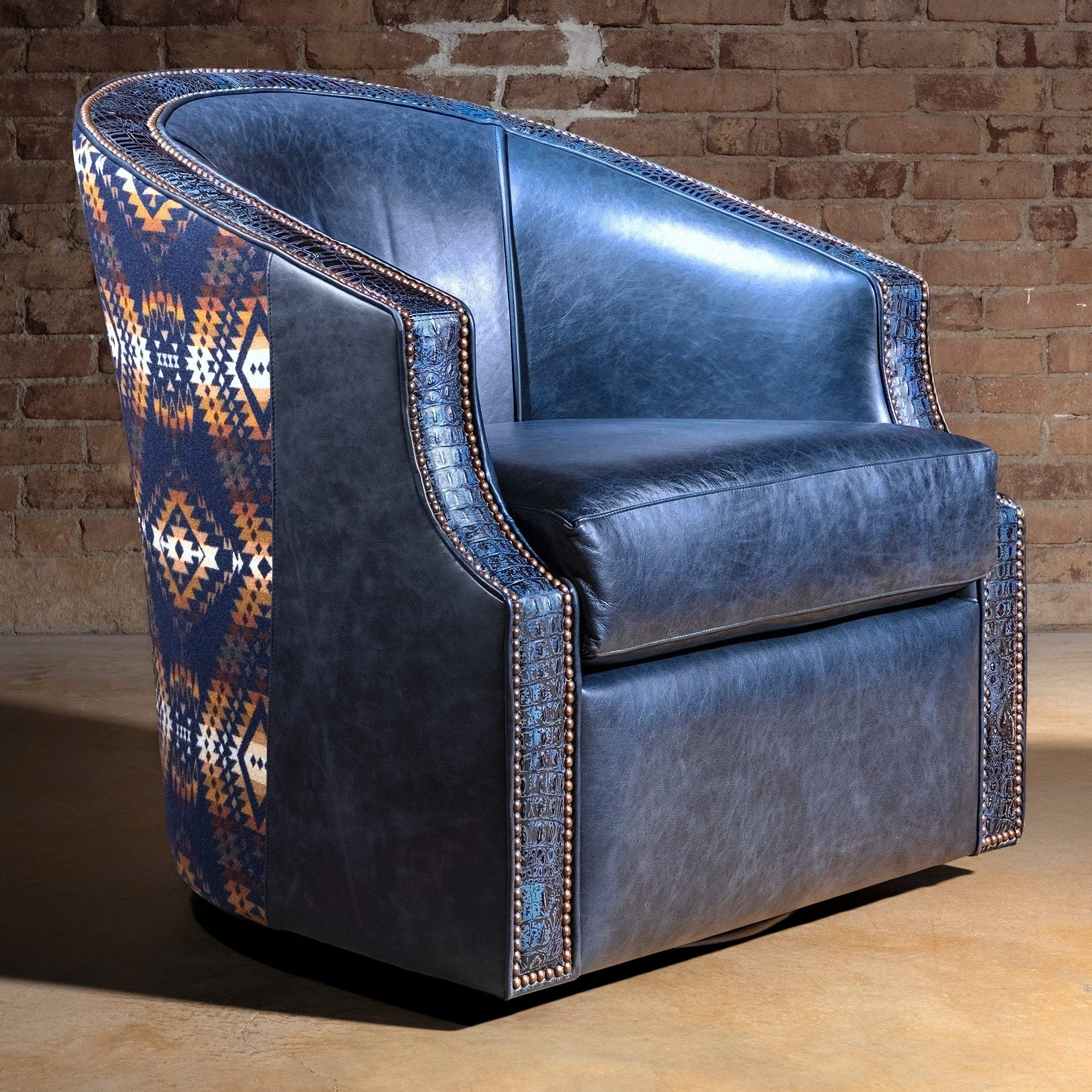 Midnight Caballero western swivel chair front view in blue leather with Pendleton textile, croc trim, nailheads, and 360-degree swivel