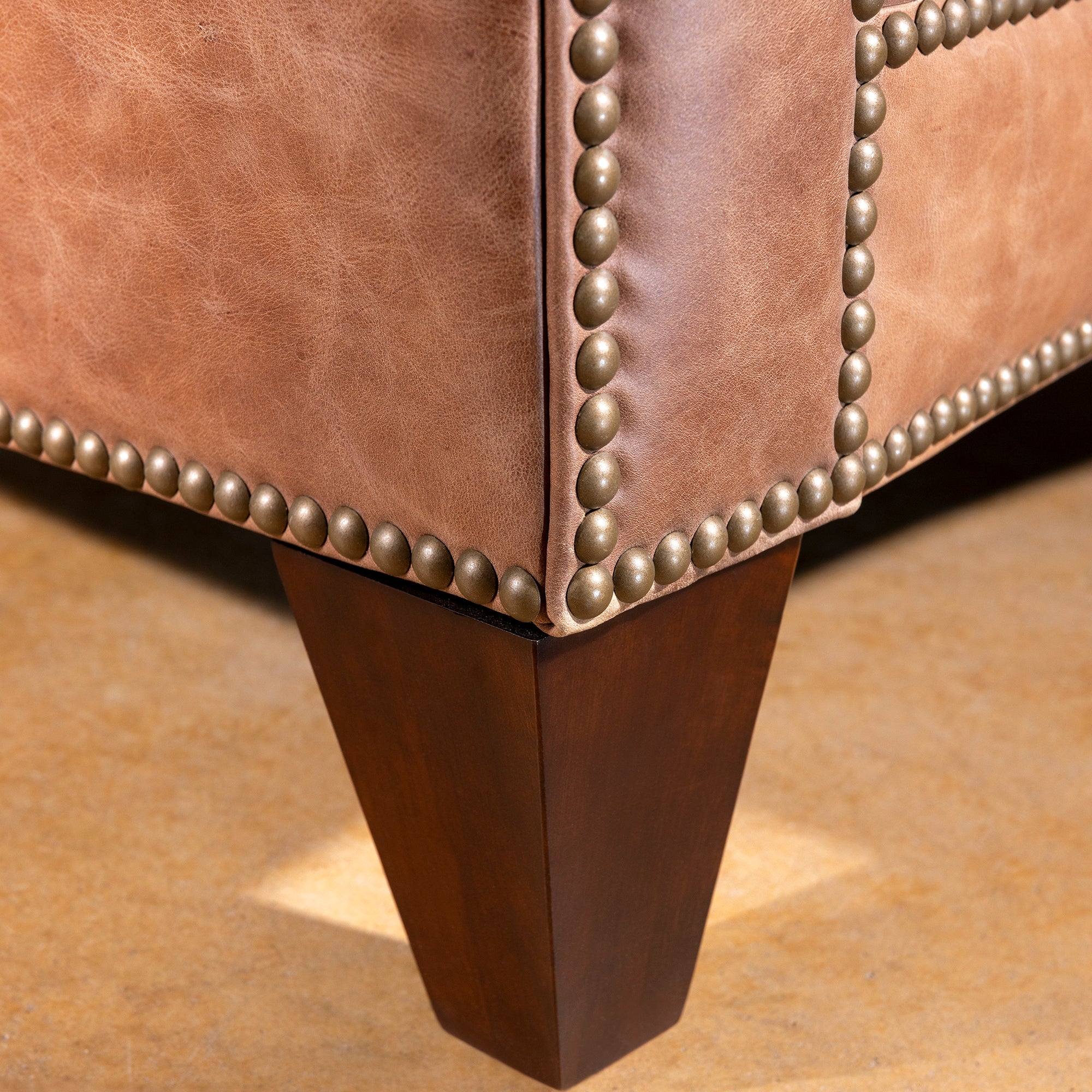 Nailhead trim and tapered wood leg detail on Oakley Frontier Western leather chair