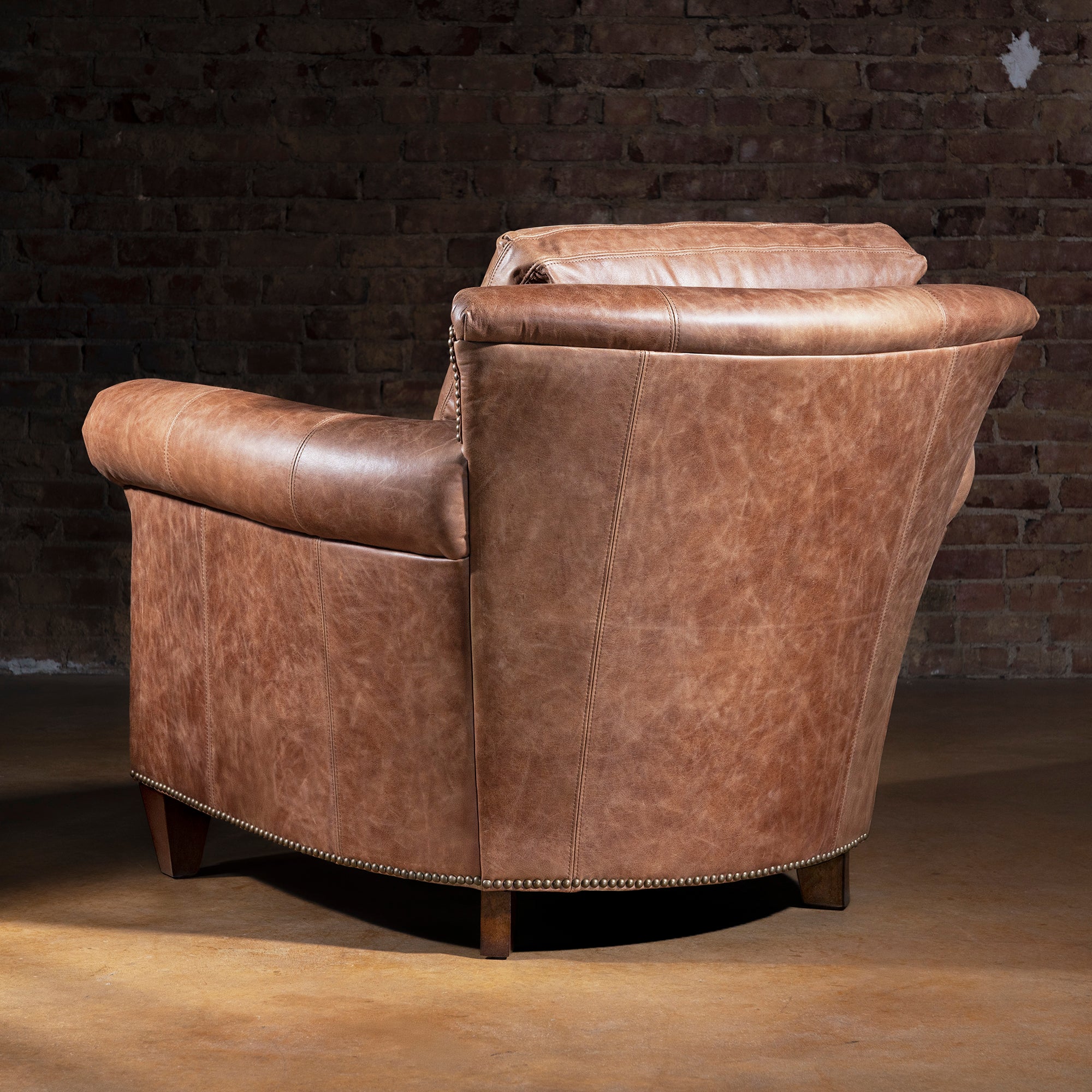 Back view of Oakley Frontier tan Western leather chair with curved frame and nailhead base