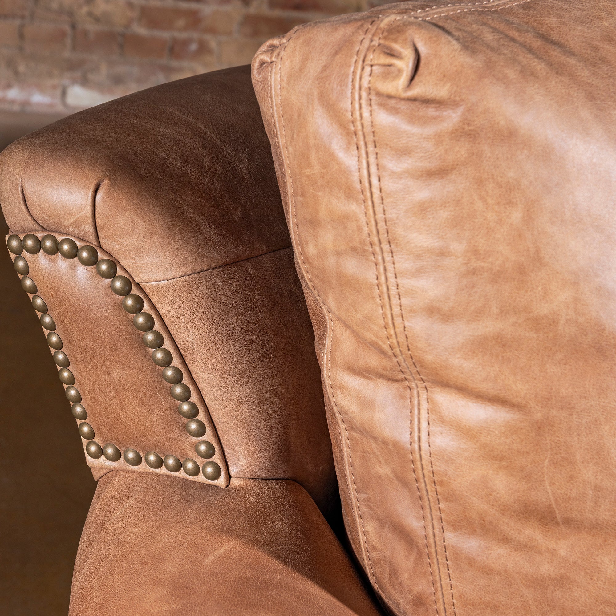 Back cushion and arm detail on Oakley Frontier Western leather couch in saddle tan leather