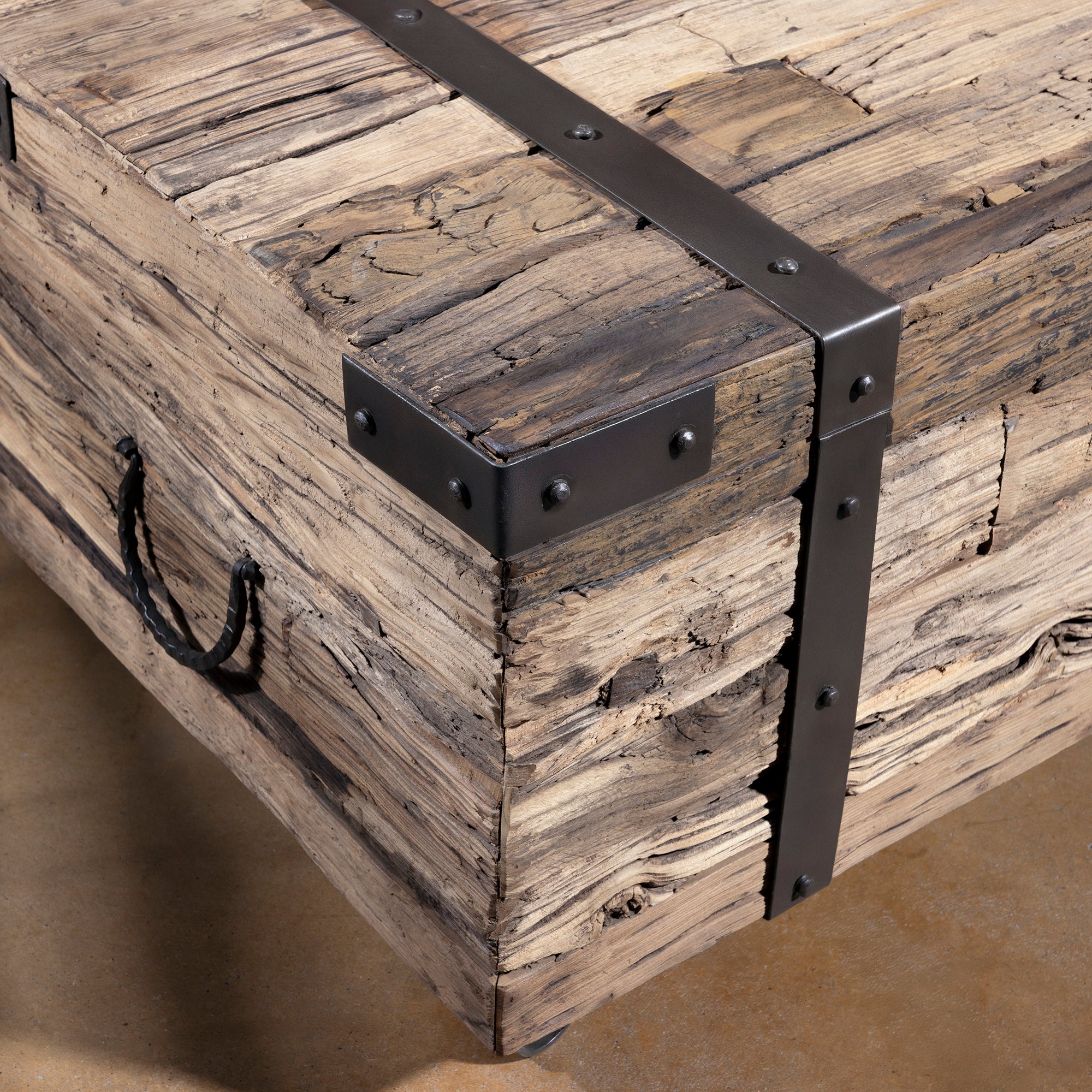 Close-up of Outlaw Freight Trunk Coffee Table iron banding and riveted hardware detail