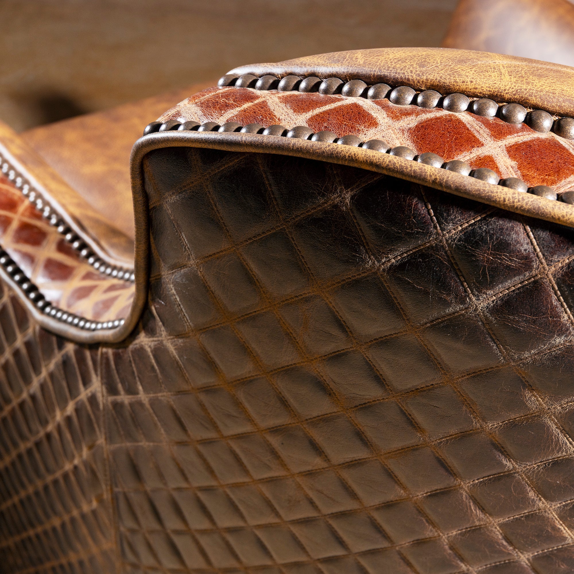 Palacio Bronce Western Leather Swivel Chair close-up with distressed leather, diamond-embossed panels, nailheads, and swivel base.