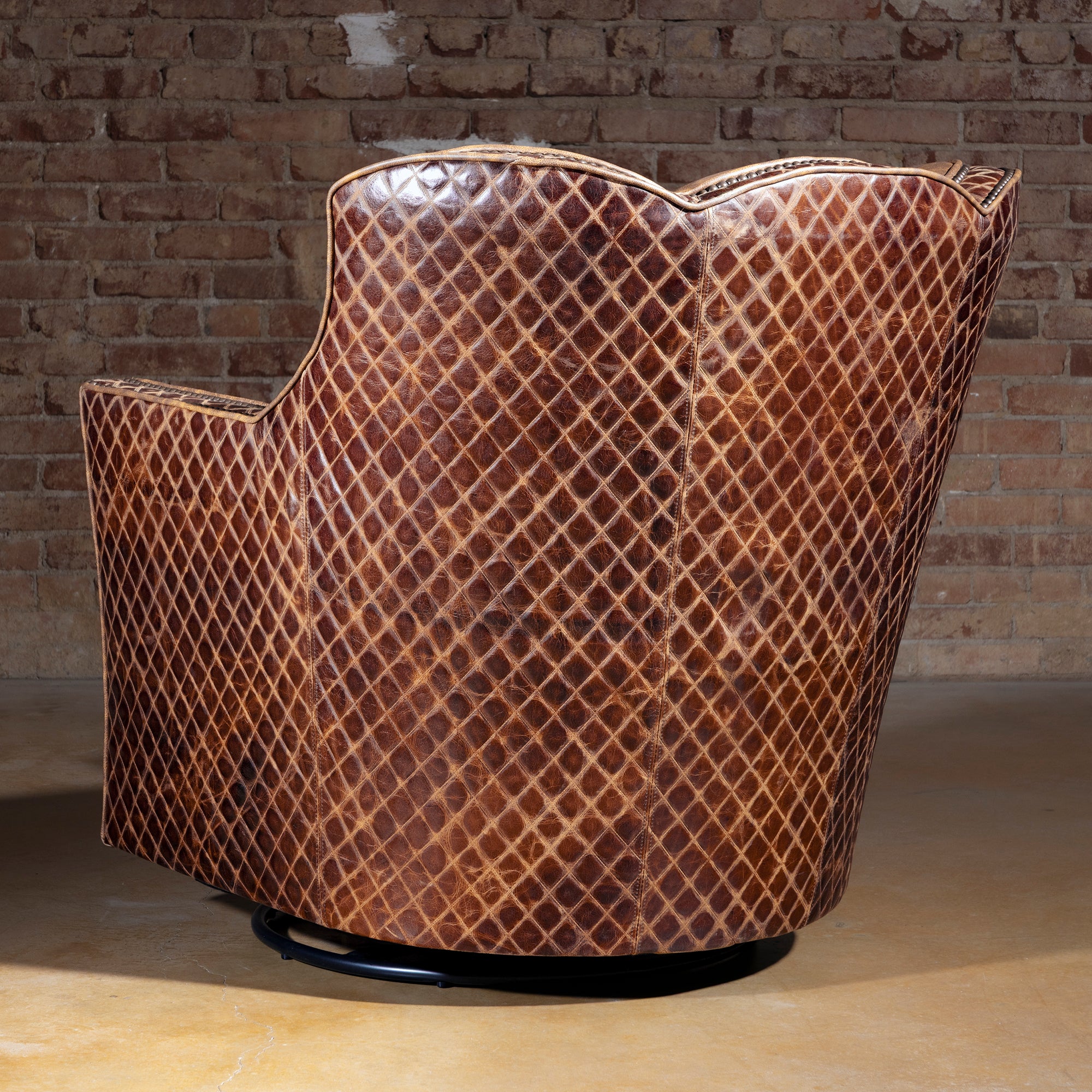 Palacio Bronce Western Leather Swivel Chair rear view with diamond-embossed leather, sculpted wingback, and 360-degree base.