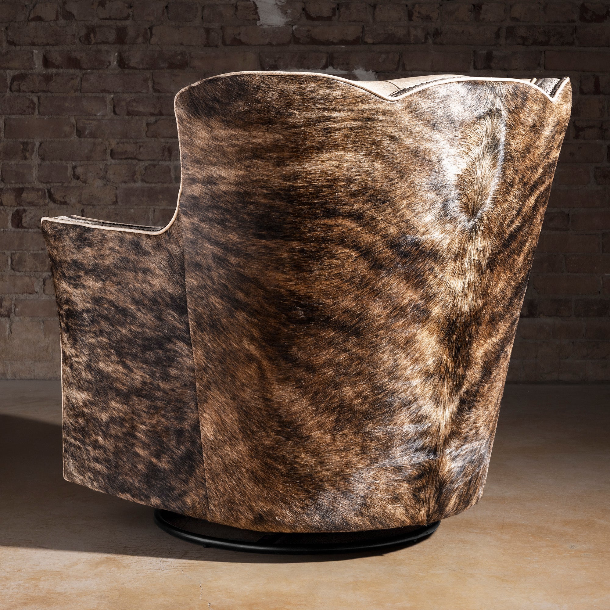 Back view of Prairie Pearl leather swivel chair showing brindle Brazilian cowhide wrap